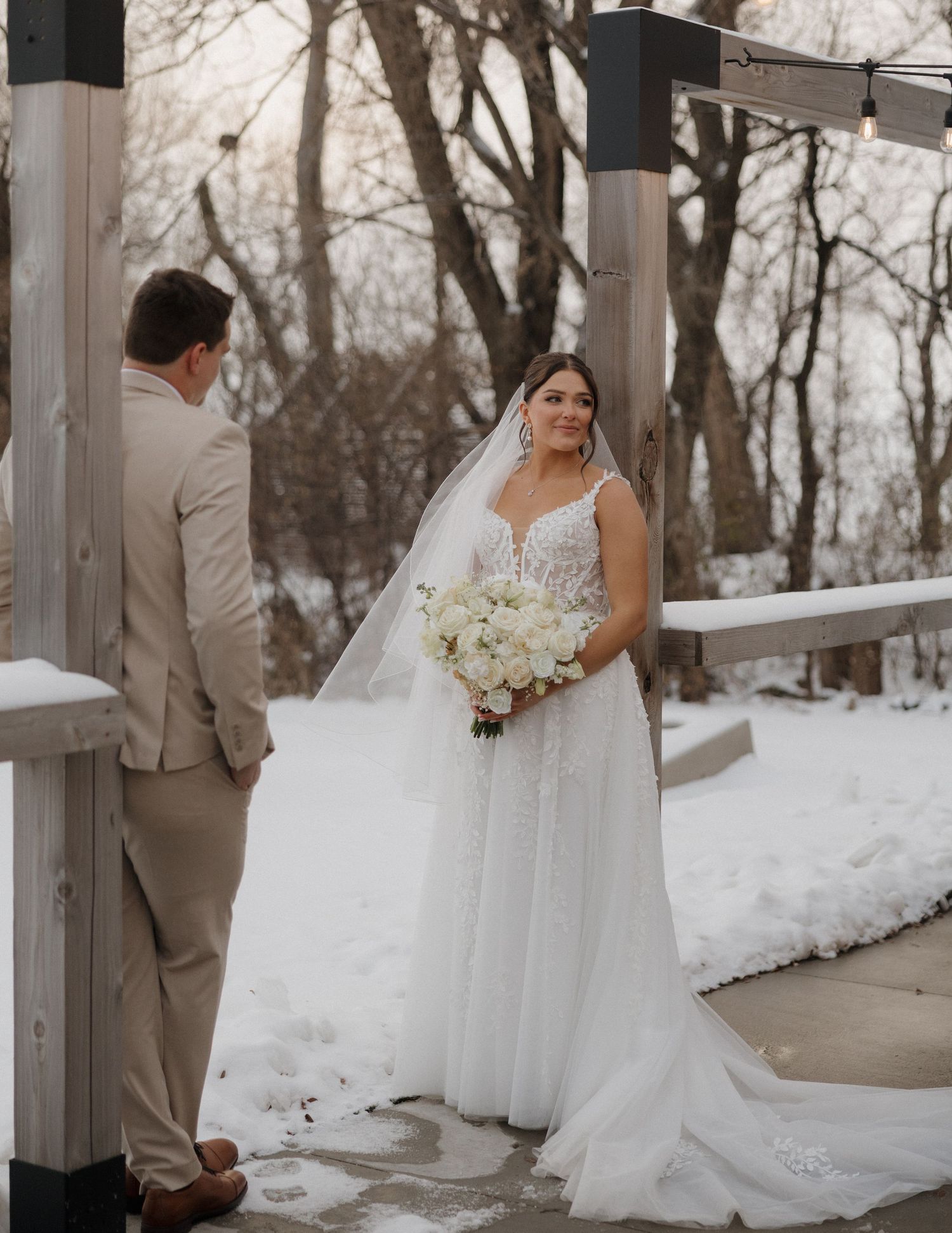 A winter wedding photo series showing a bride in a white gown and groom in tan suit on a snow-covered porch.