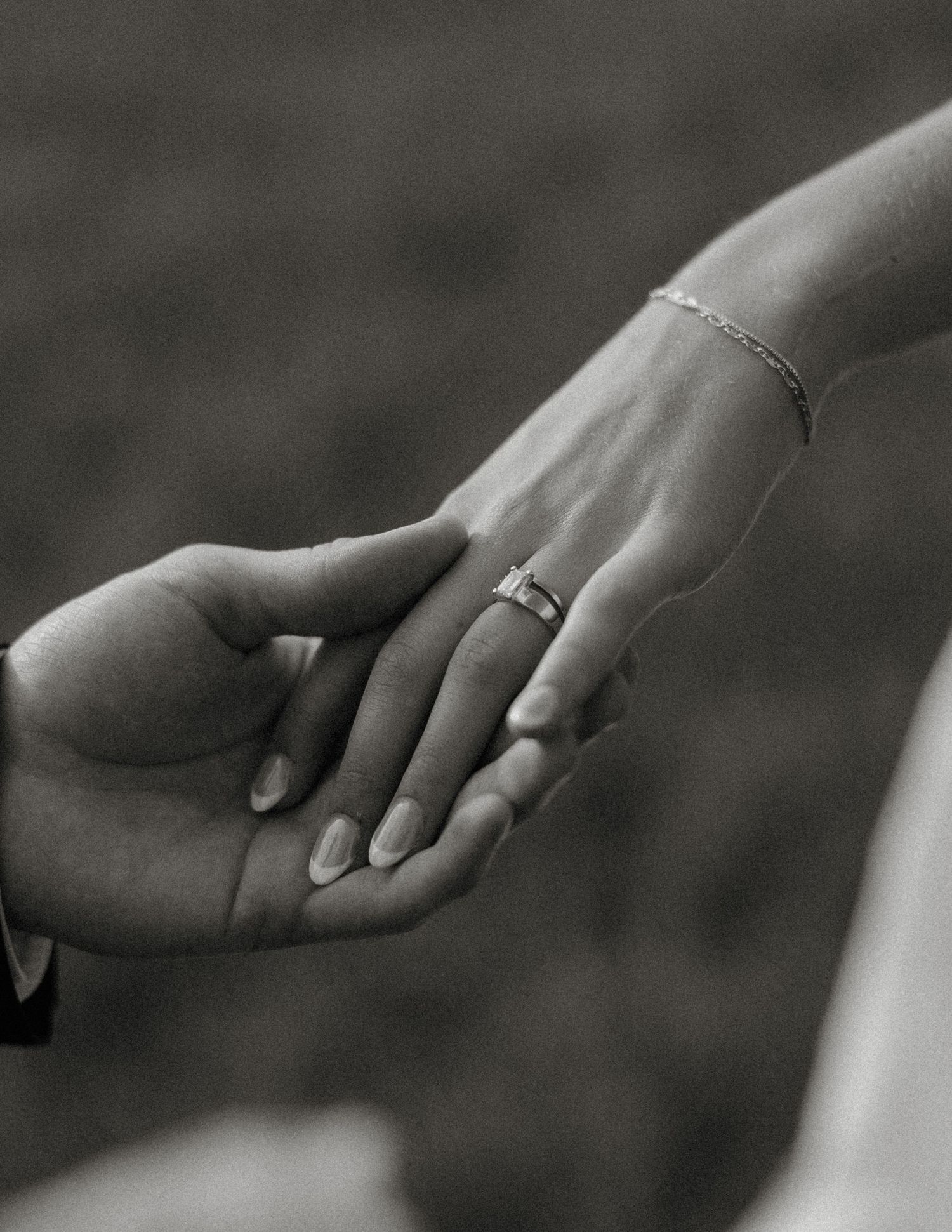 Black and white photo series showing hands gently touching and intertwining in an intimate artistic sequence.