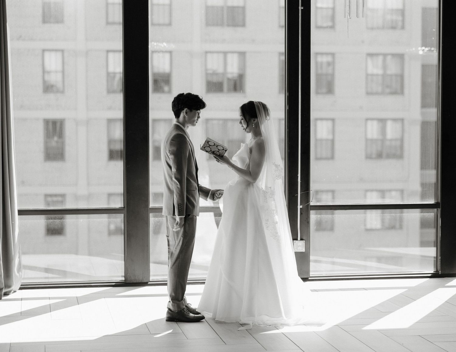 A sequence of silhouetted figures in front of bright windows creates a romantic wedding photography series.
