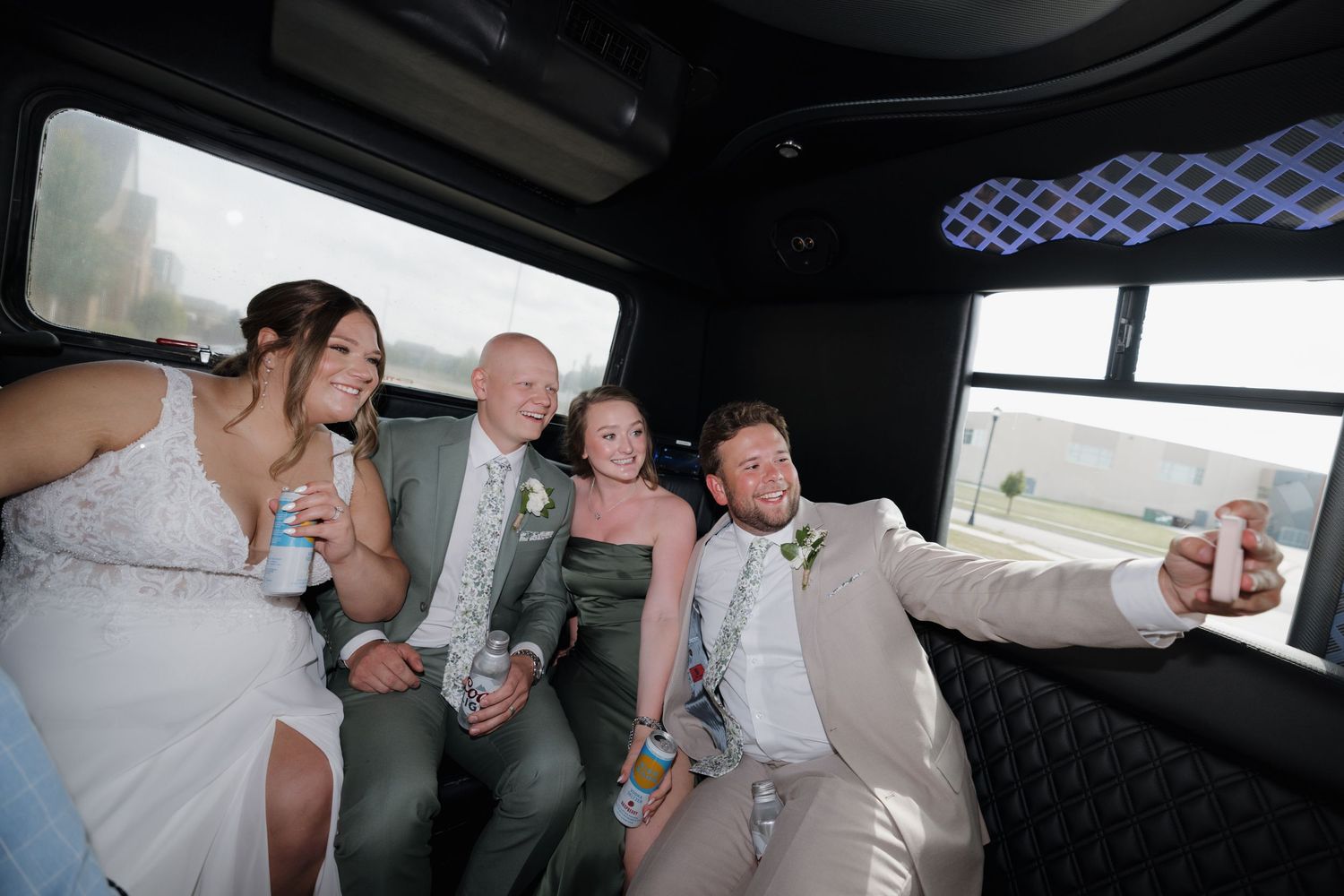 A group of passengers sit close together in what appears to be the interior of a party bus or limousine.