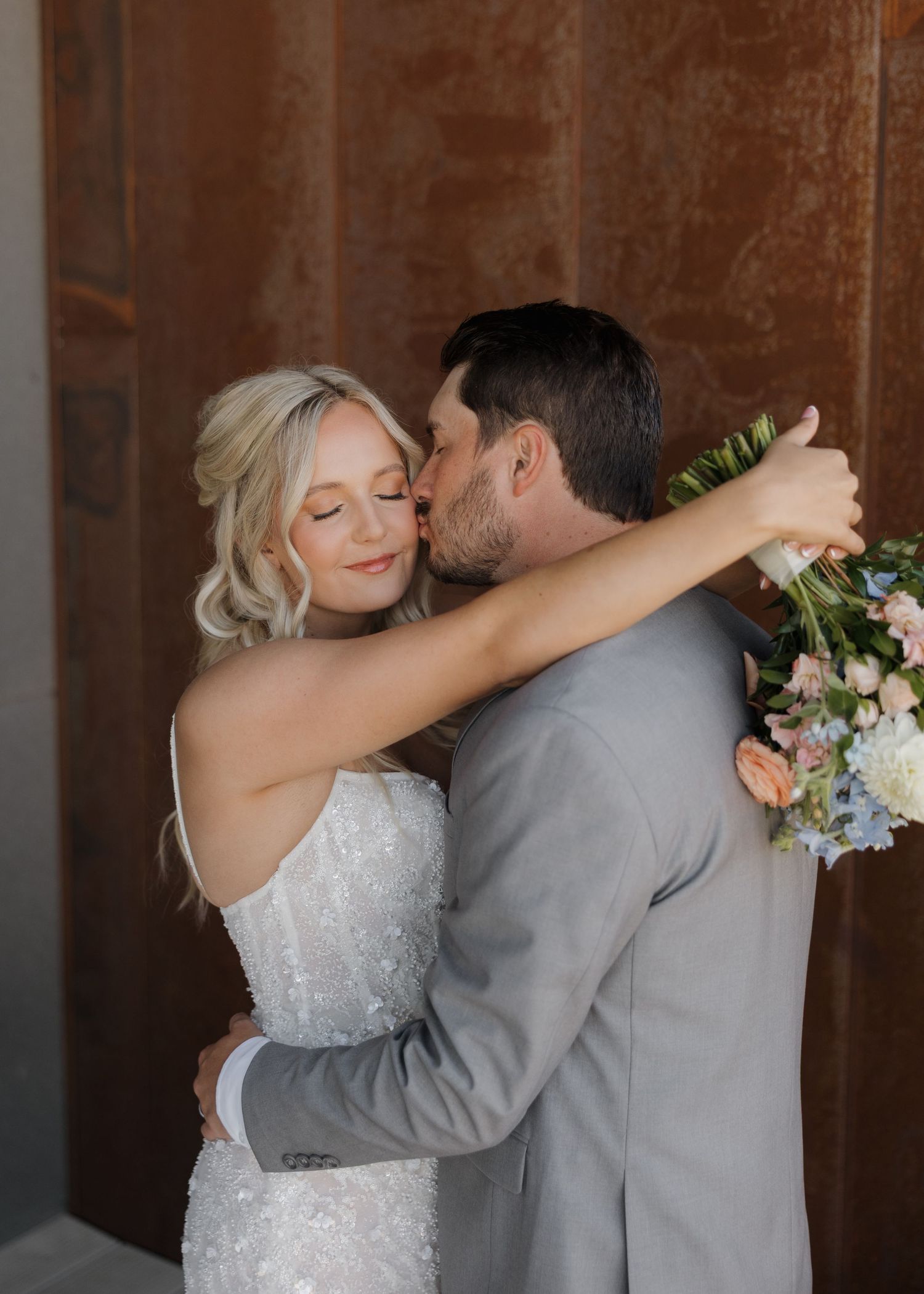 A romantic wedding moment captured in a series of five photos showing a couple embracing in their wedding attire.