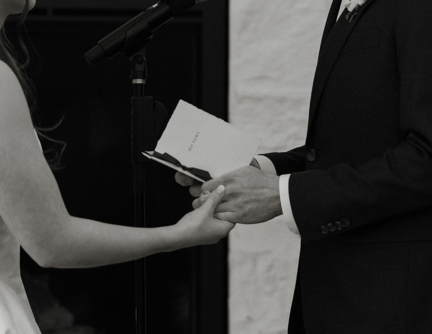 A series of black and white photos showing people in business attire exchanging and reviewing documents.