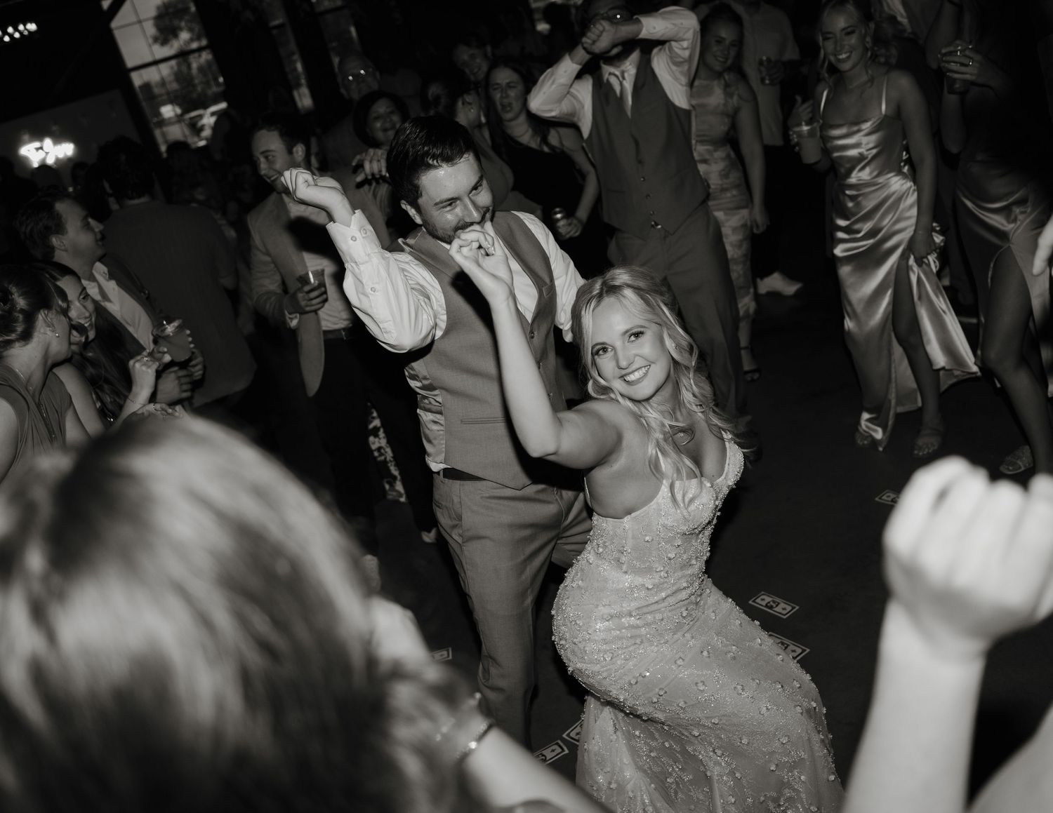 Black and white photos show people dancing and socializing at what appears to be a lively party or nightclub event.