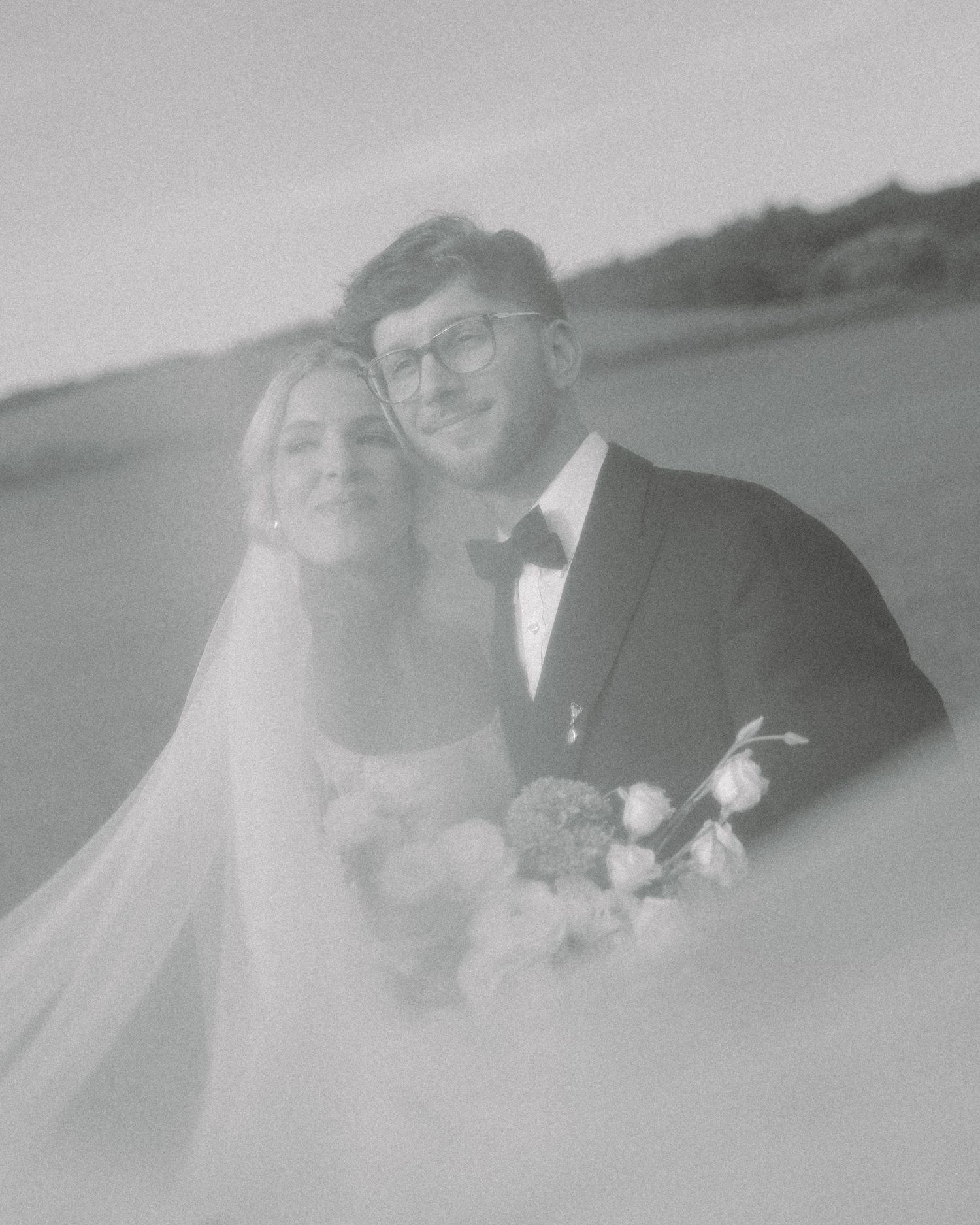 A vintage black and white wedding portrait series showing a couple in formal attire with veil and bouquet.