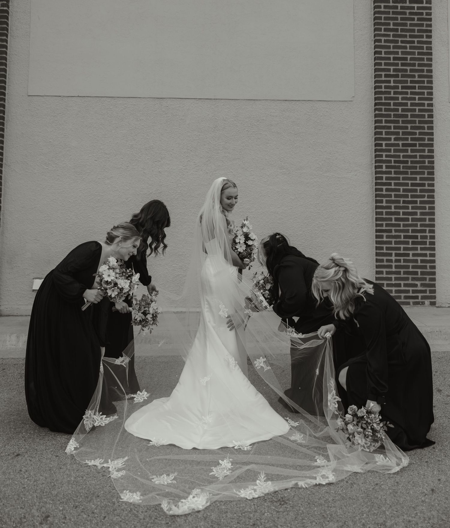 A sequence of four black and white wedding photos showing a bride in a flowing veil kneeling on the ground.