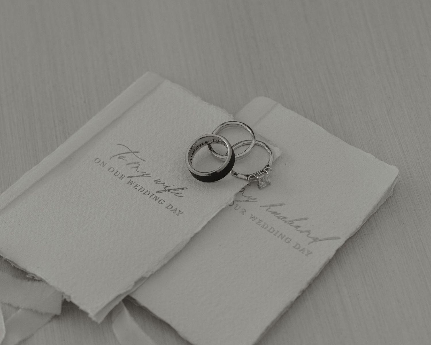 Elegant wedding invitation suite displayed on a light gray background.