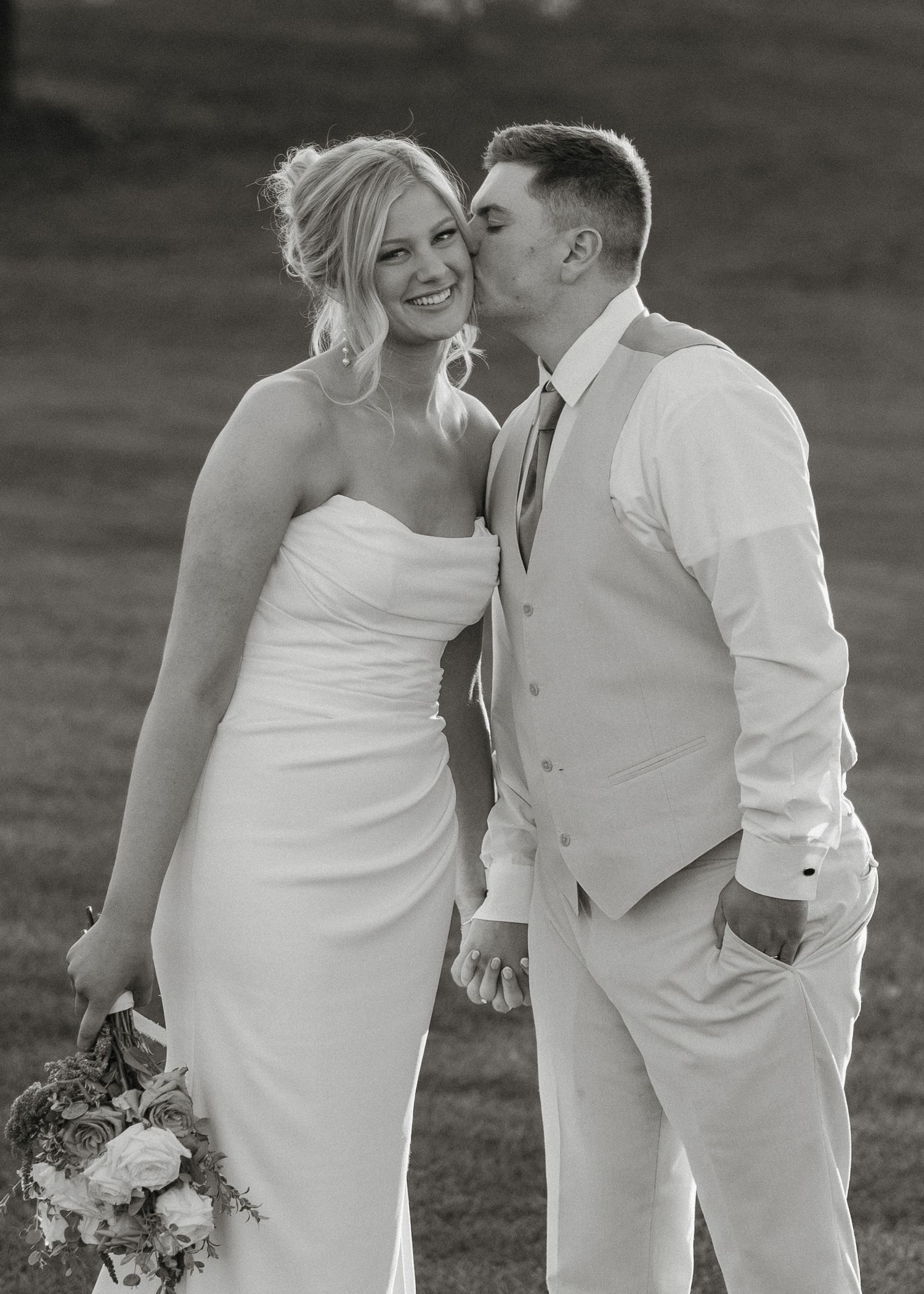 A romantic black and white wedding photo series showing a couple embracing outdoors in formal attire with a bouquet.
