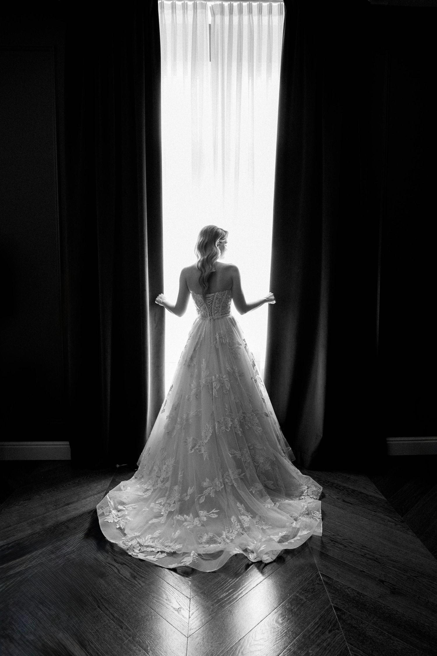 A series of silhouetted bridal gown photos against bright windows showing the dramatic train and lace details.