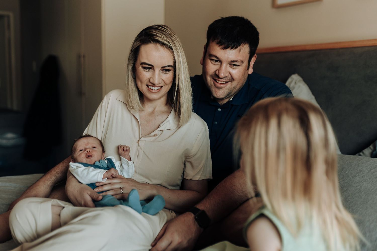 A heartwarming collection of images showing parents bonding with their newborn baby in a cozy home setting.