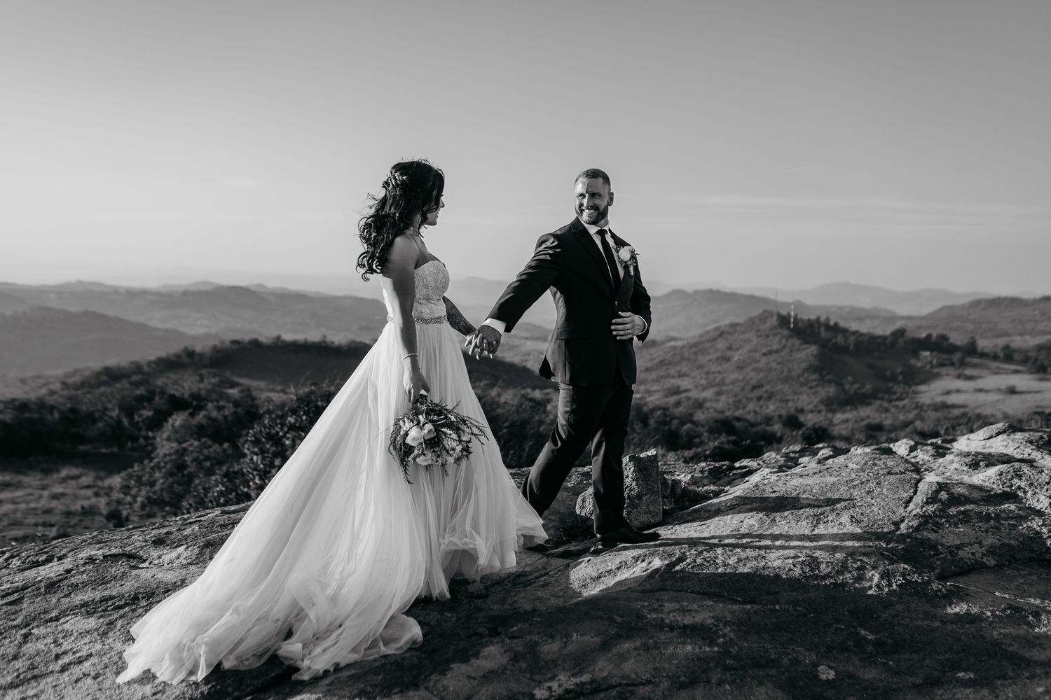 Black and white scenic mountaintop wedding series showing romantic moments during a sunset ceremony with sweeping views.