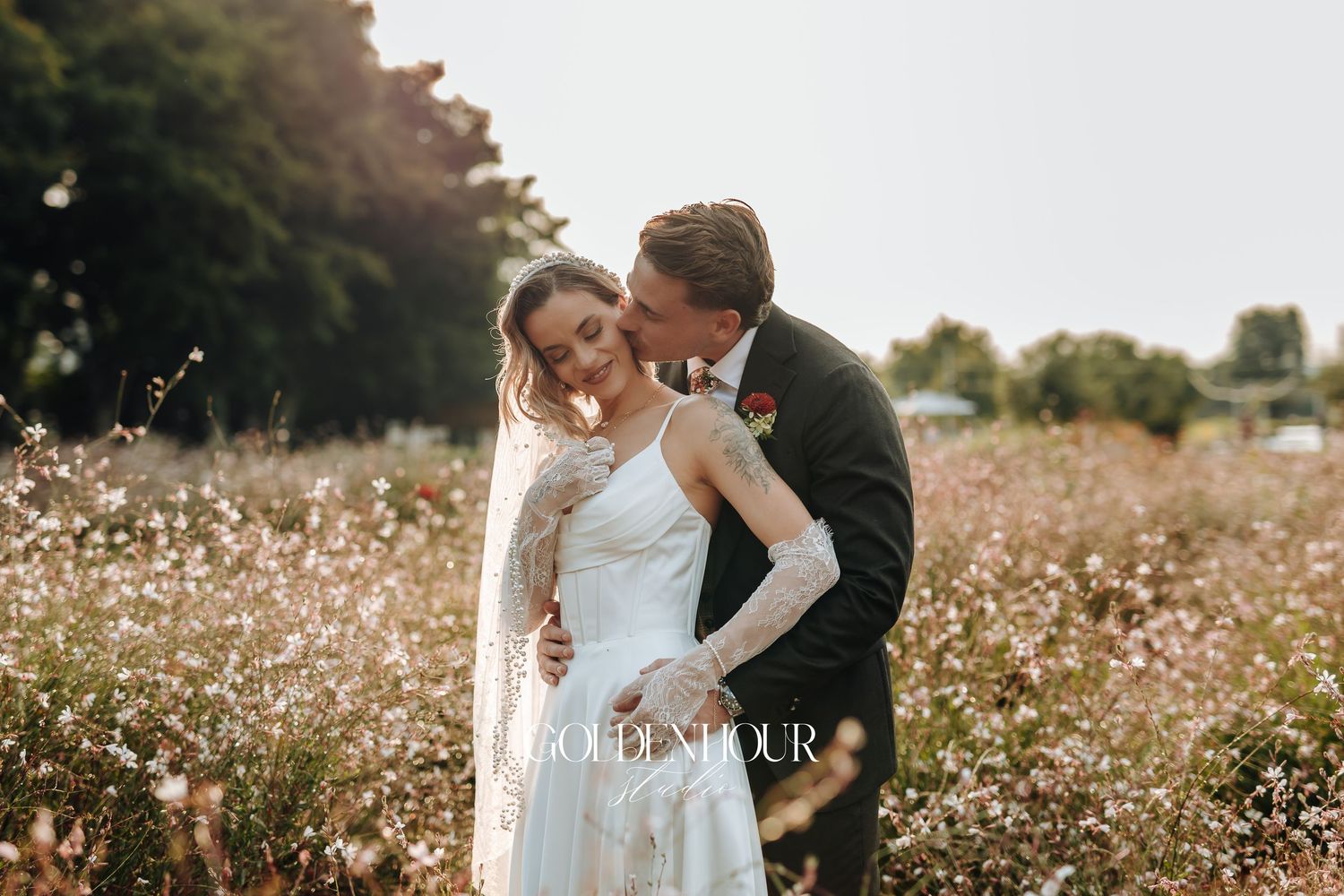 Romantic couple portrait in wildflower field during golden hour.