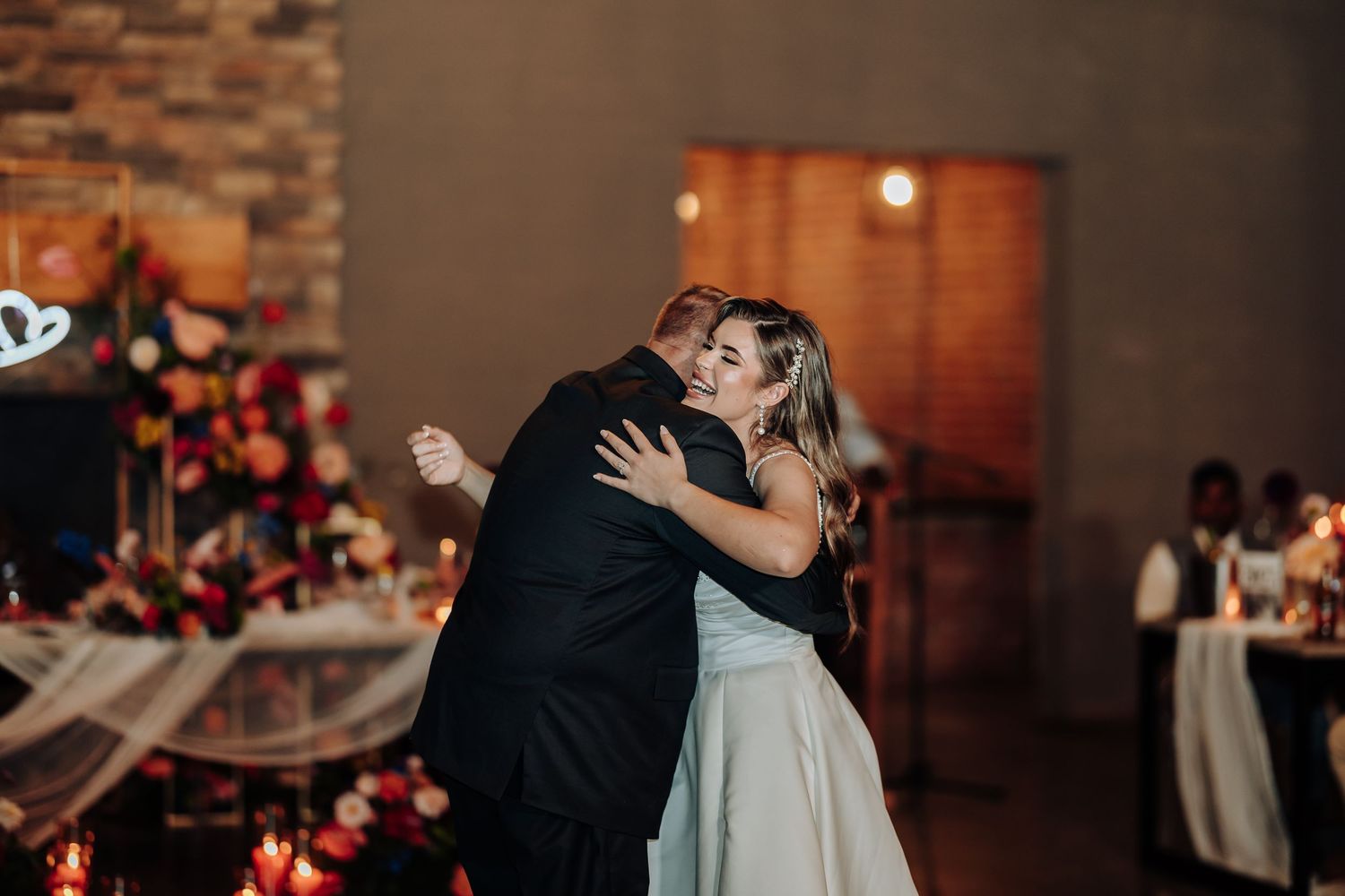 A couple embraces during an intimate dance moment at their wedding reception.