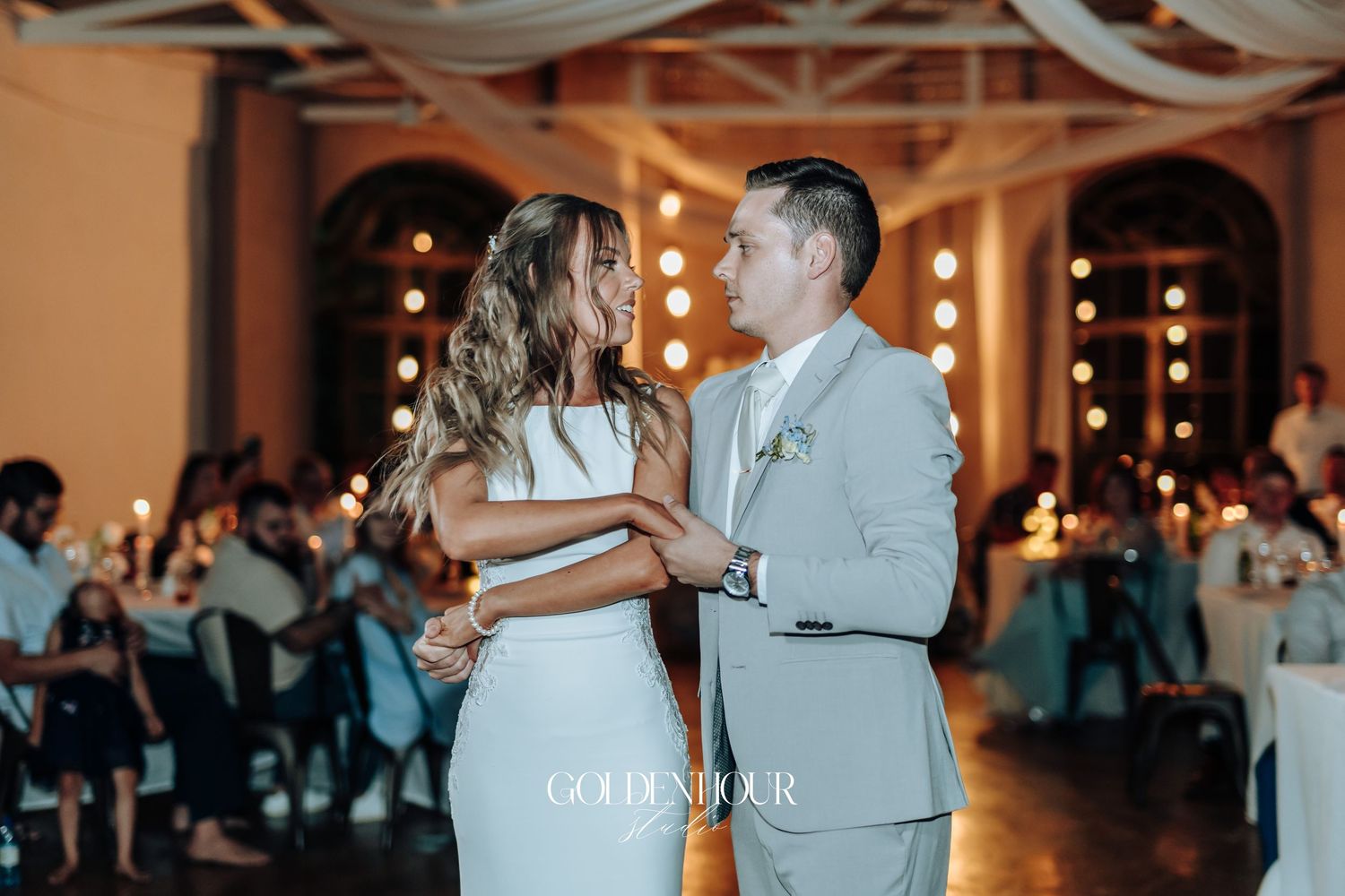 Wedding reception dance floor scene with warm lighting and festive atmosphere.