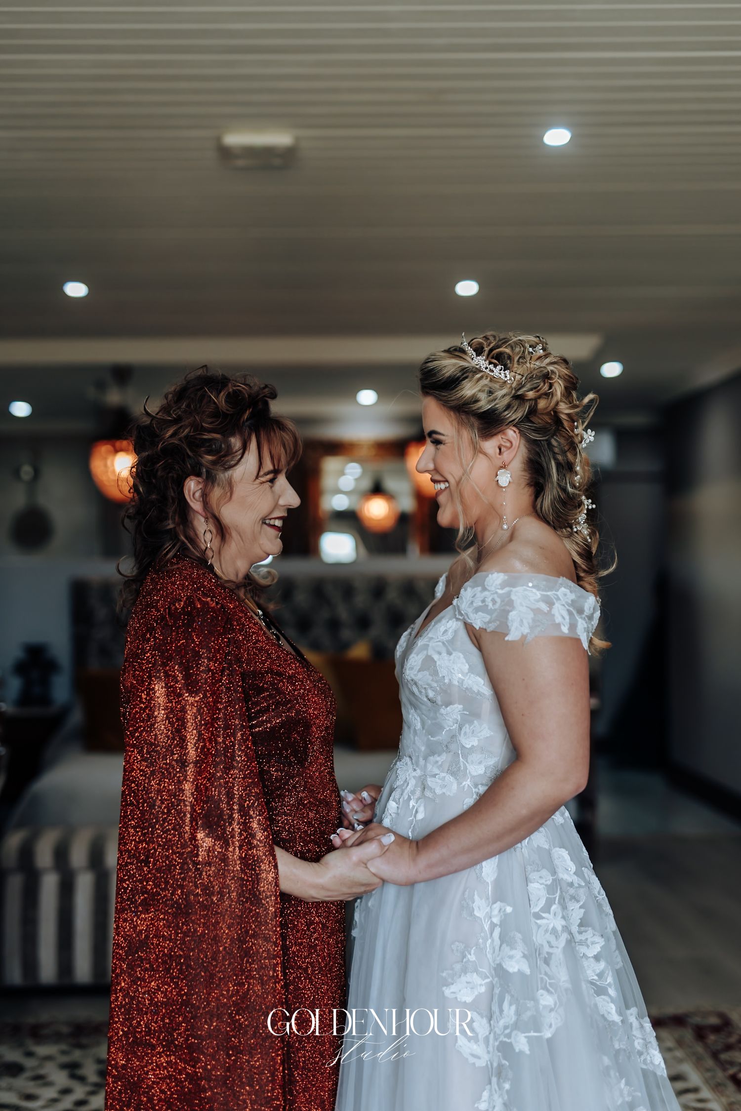 Joyful bride and mother sharing a heartfelt moment together before the wedding ceremony.
