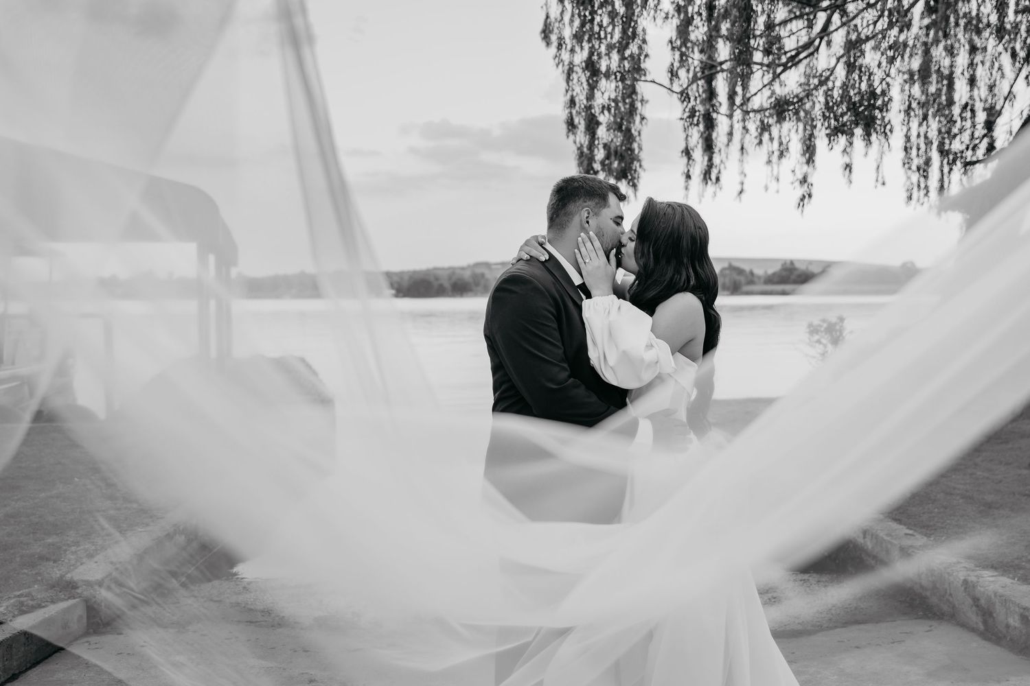Black and white wedding photo collage showing romantic moments and flowing veil details in natural outdoor settings.