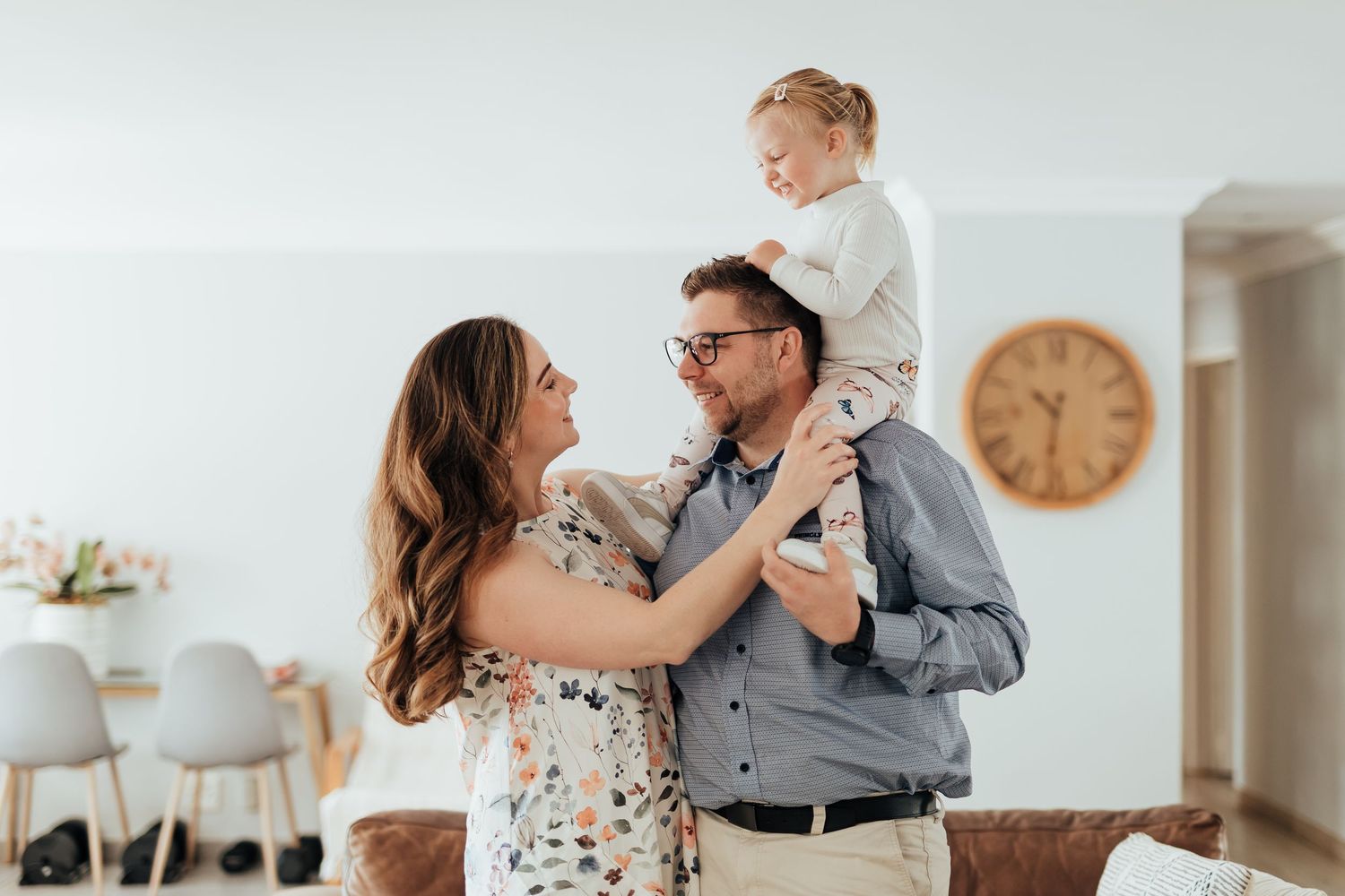 A romantic engagement photography session showing tender moments between a couple in a bright indoor setting.