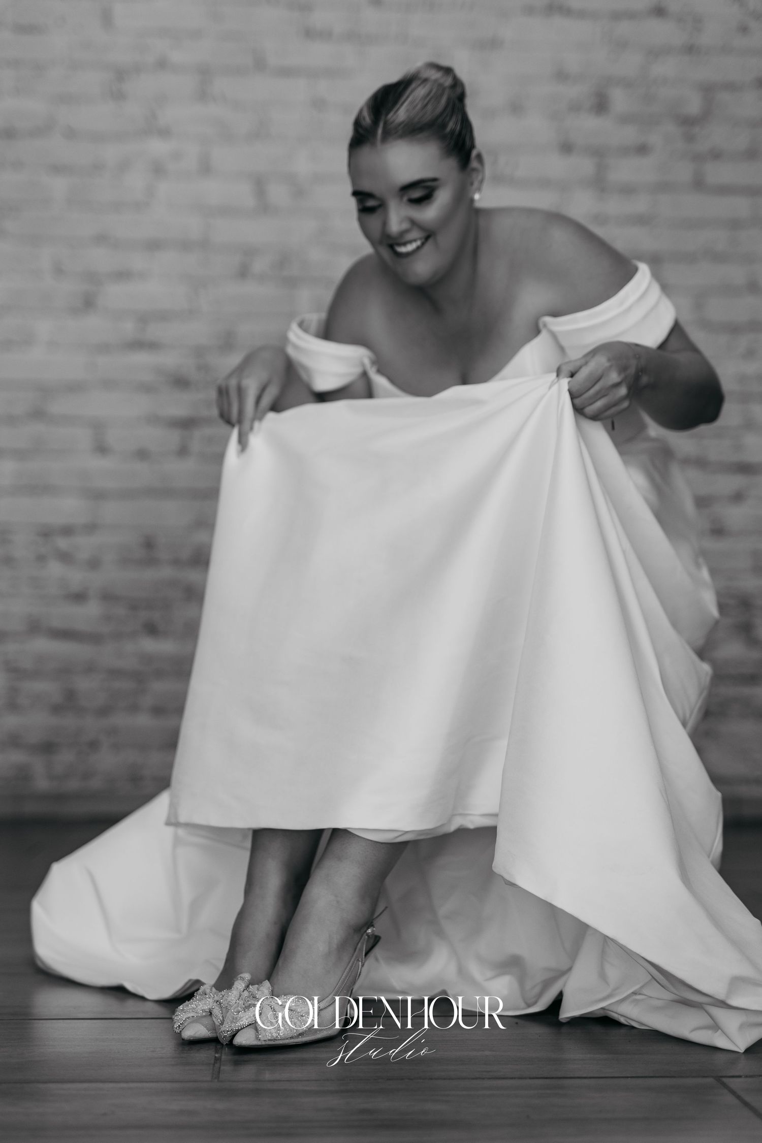 Black and white photo series showing bride in white dress sitting and adjusting her gown with a joyful expression.