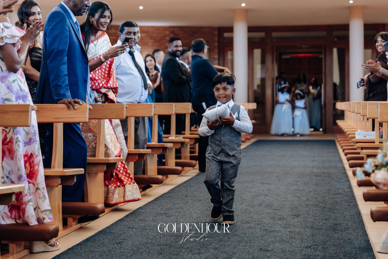 Wedding guests seated in church pews during a ceremony.