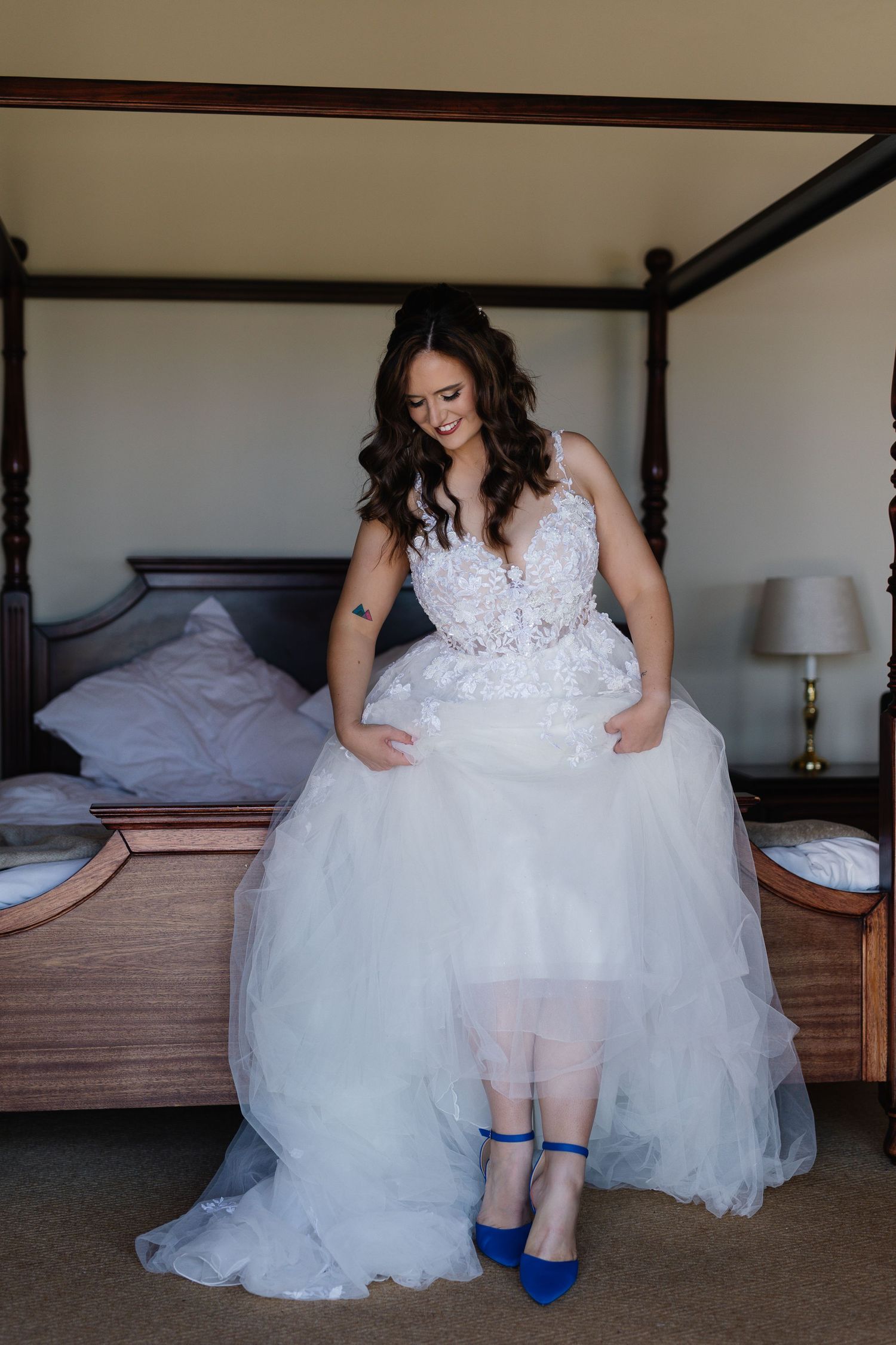 A series of wedding preparation photos showing bright blue shoes peeking out from under a white tulle wedding gown.