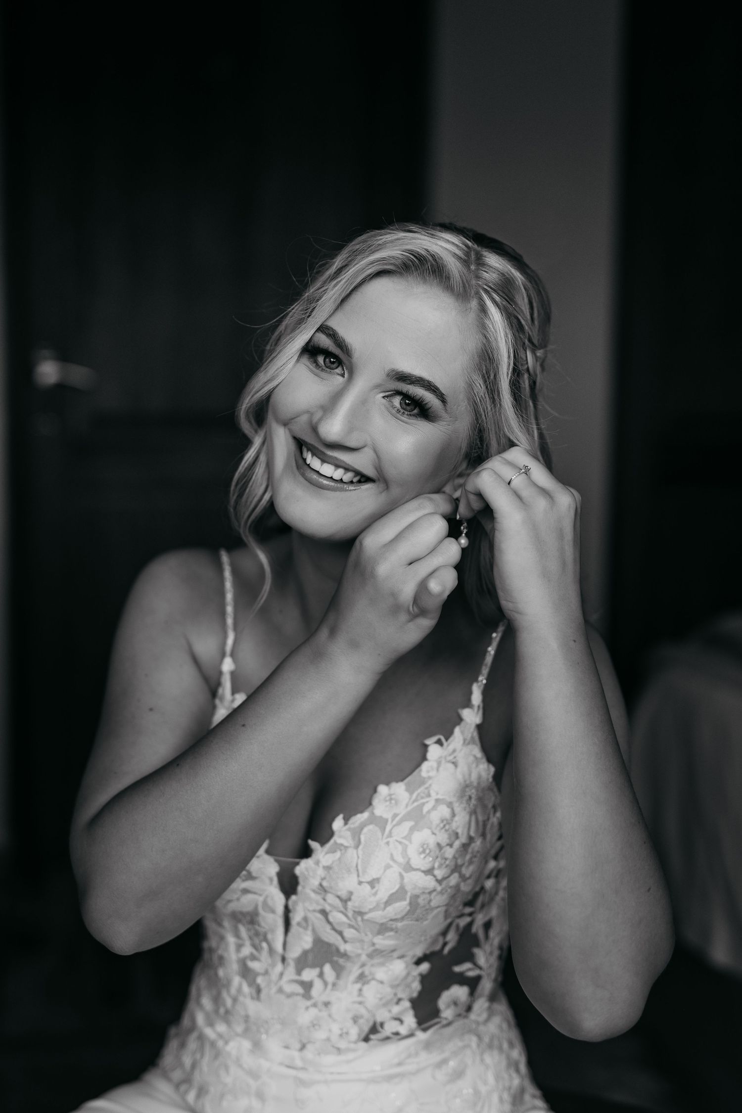 A series of black and white photos showing emotional moments of a bride in a lace wedding dress.