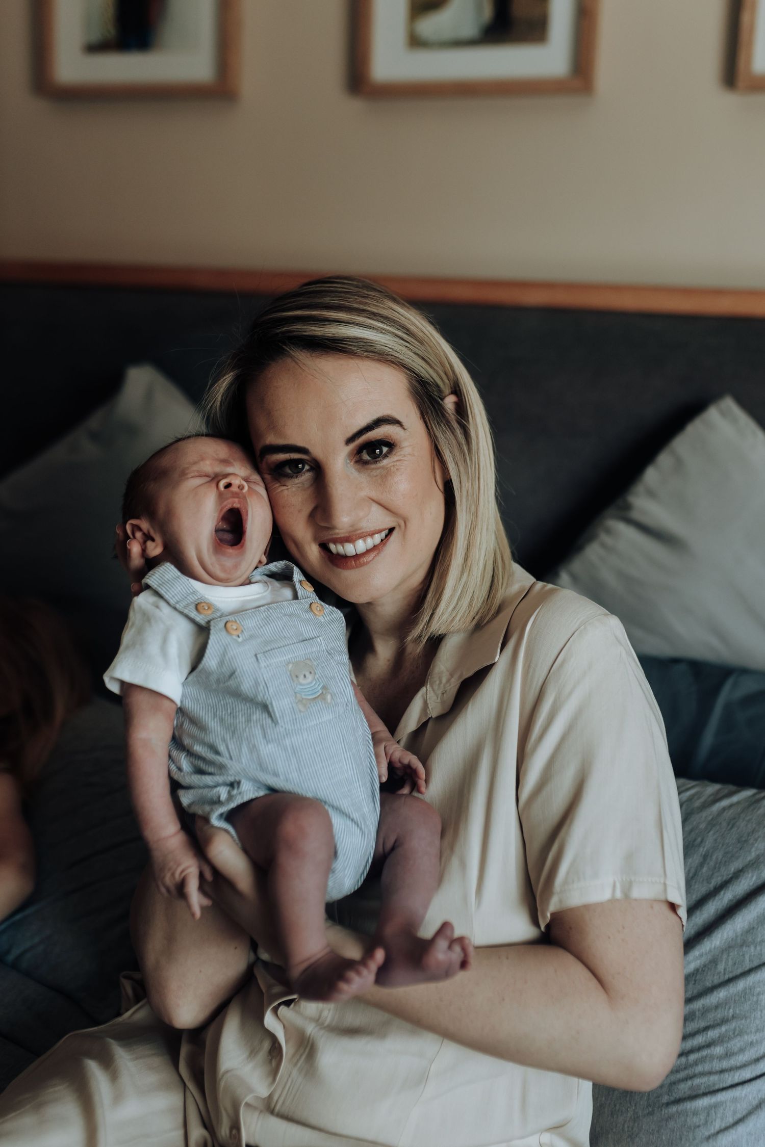 A series of intimate lifestyle photos showing tender moments with a newborn baby on a couch in soft, natural lighting.