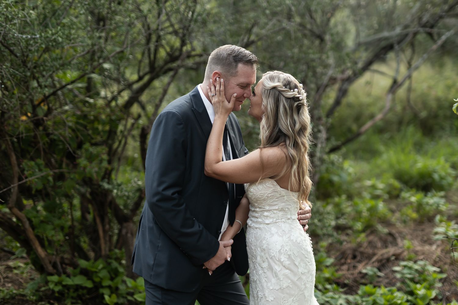An intimate wedding moment shared between a couple in a garden setting.