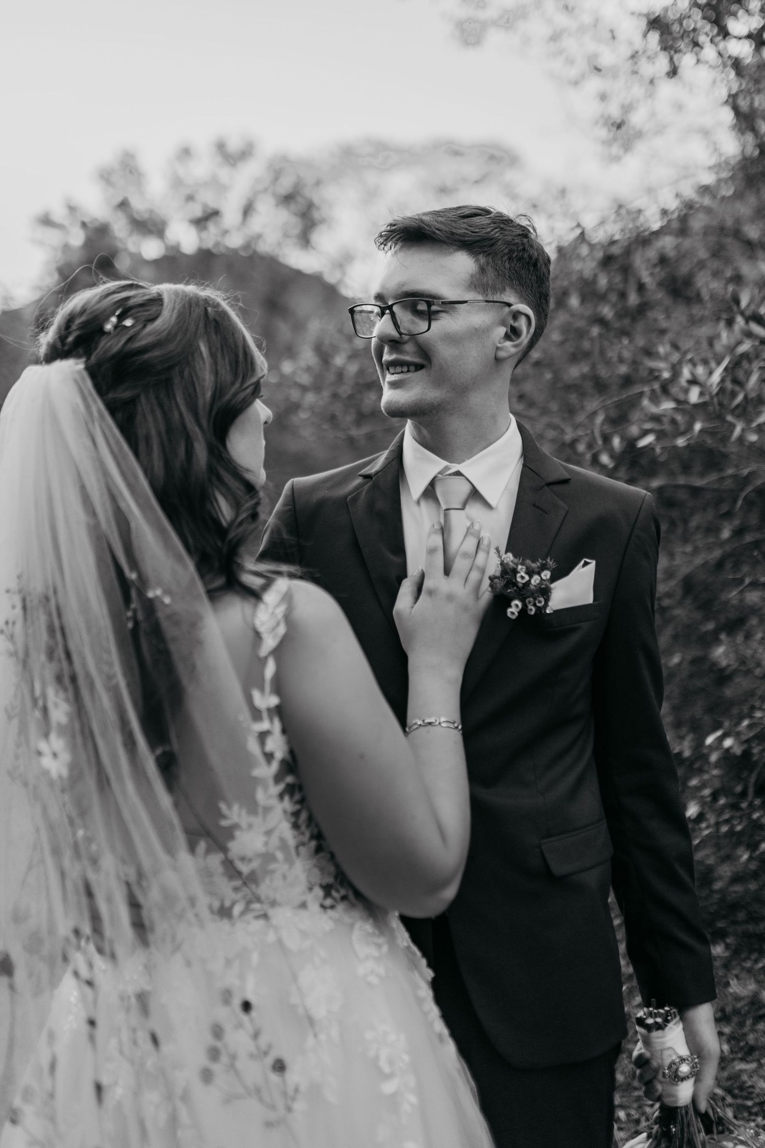 A romantic black and white photo sequence shows a couple sharing intimate moments and laughter during their wedding day.