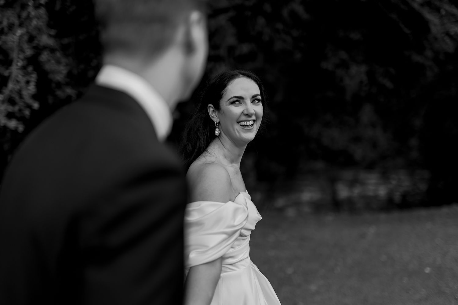 A candid black and white wedding photo capturing laughter and joy.