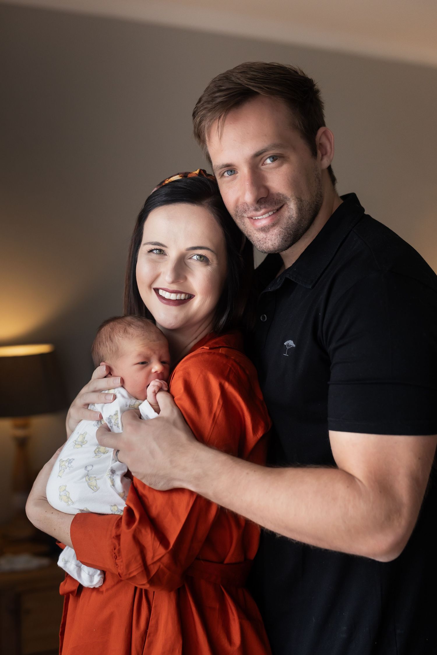 Five intimate portraits showing affectionate family moments with a baby in a home setting.