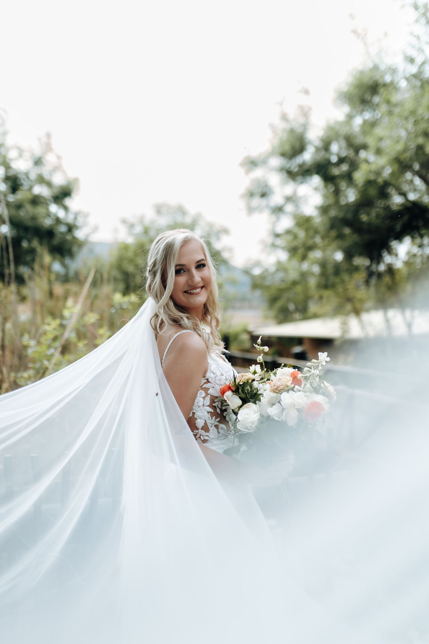 A flowing white wedding dress and bouquet captured in a series of ethereal outdoor bridal portraits.