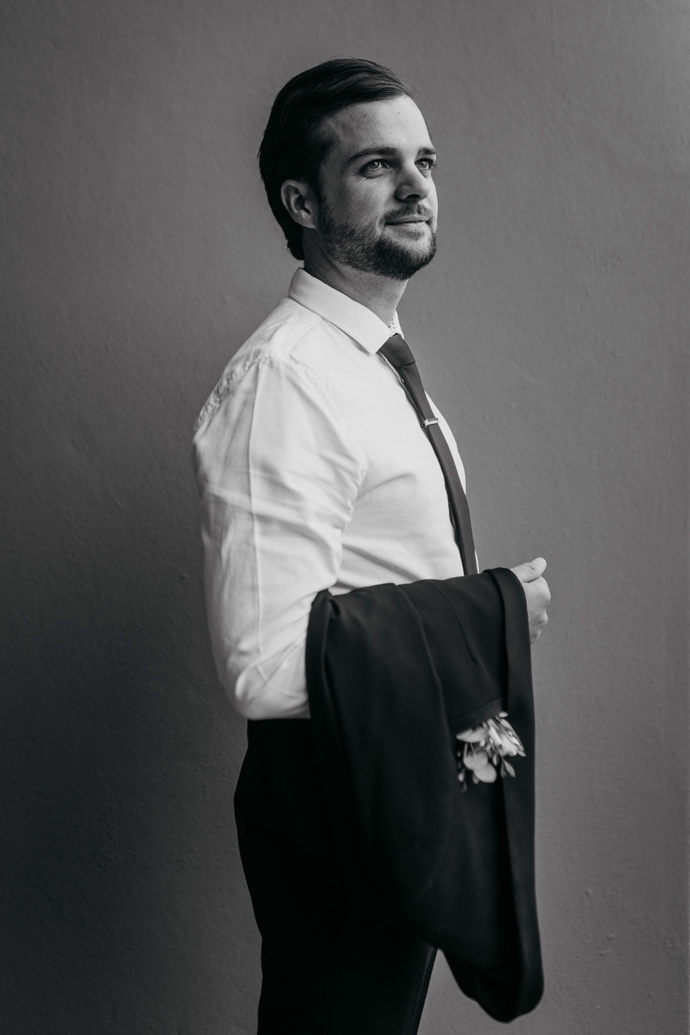 Black and white portrait in formal attire against plain background.