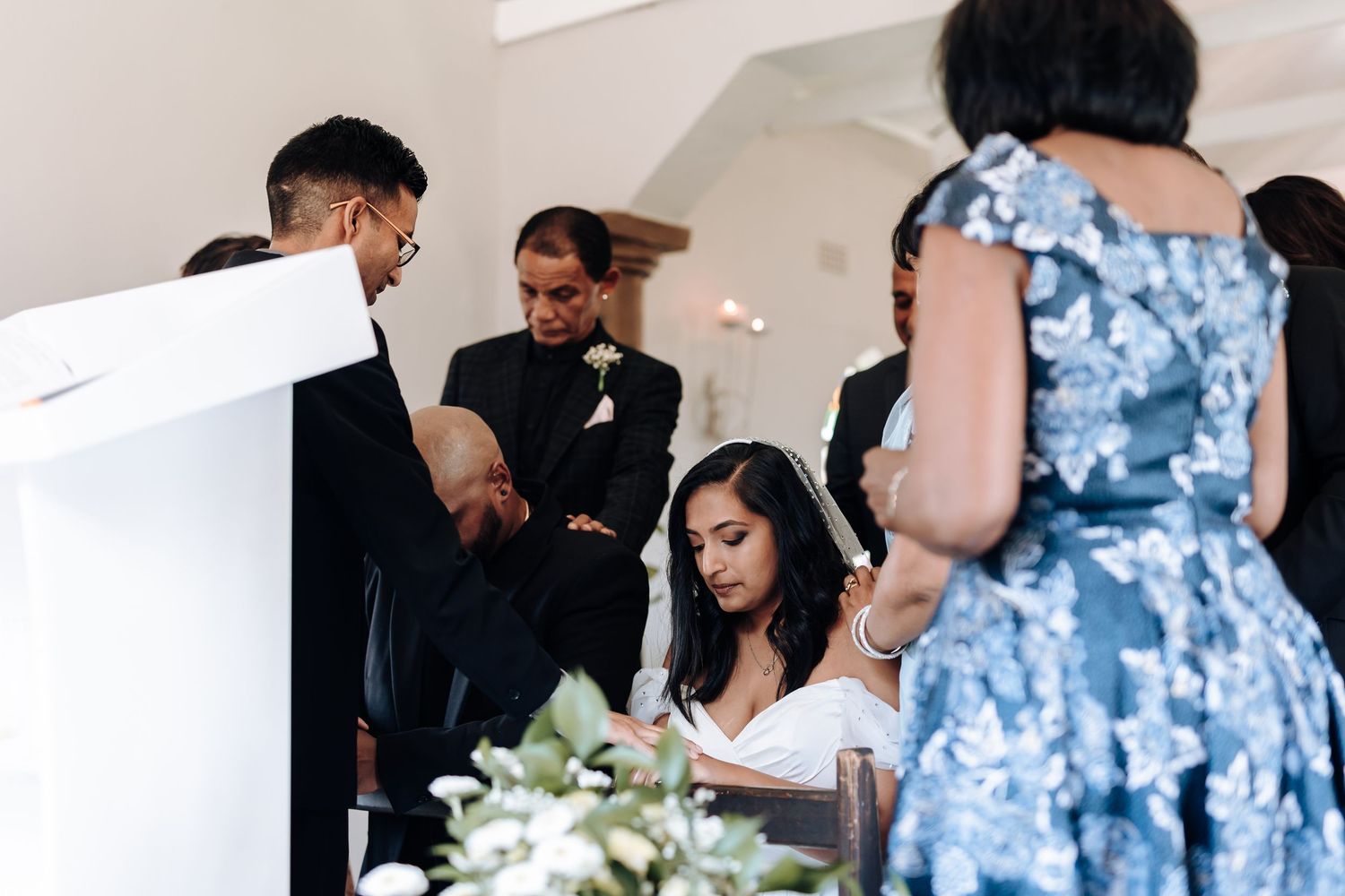 Wedding ceremony document signing with family members in church.