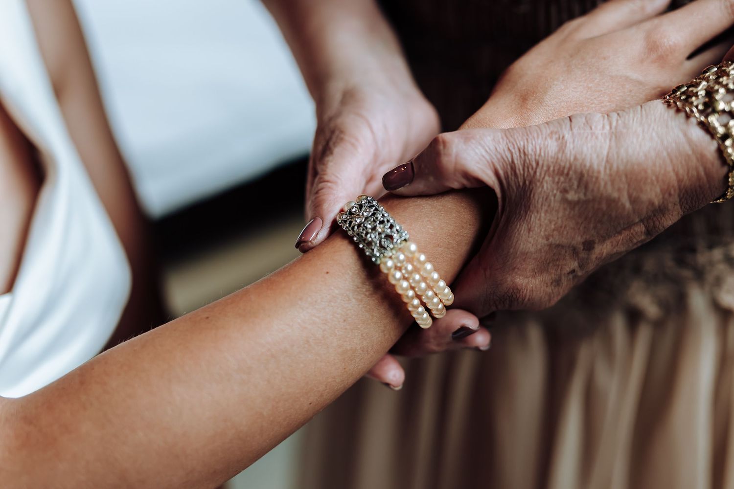 Close-up shots of hands exchanging wedding rings during a ceremony, with elegant jewelry details visible.