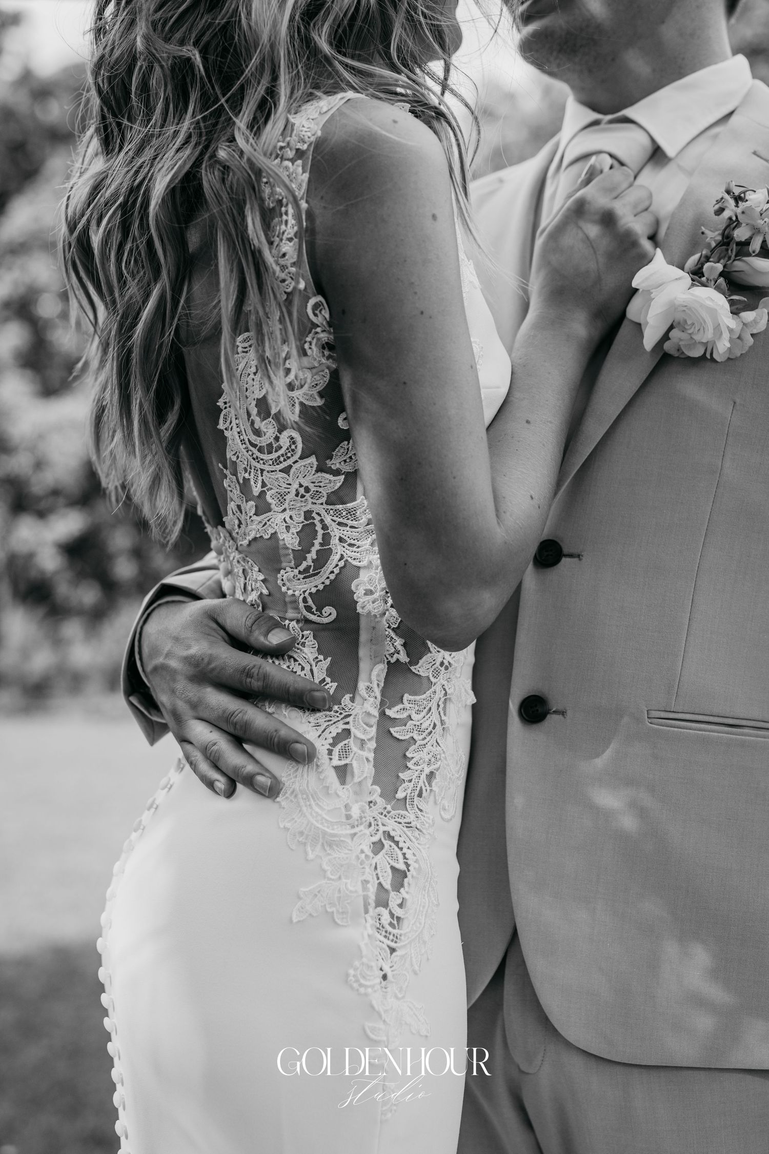 Close-up details of lace wedding dress and intimate couple poses in black and white.