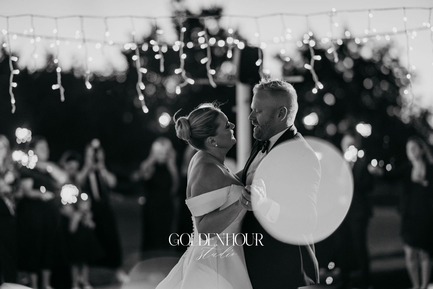 A black and white wedding photo collage showing romantic moments and dancing at an outdoor evening reception.