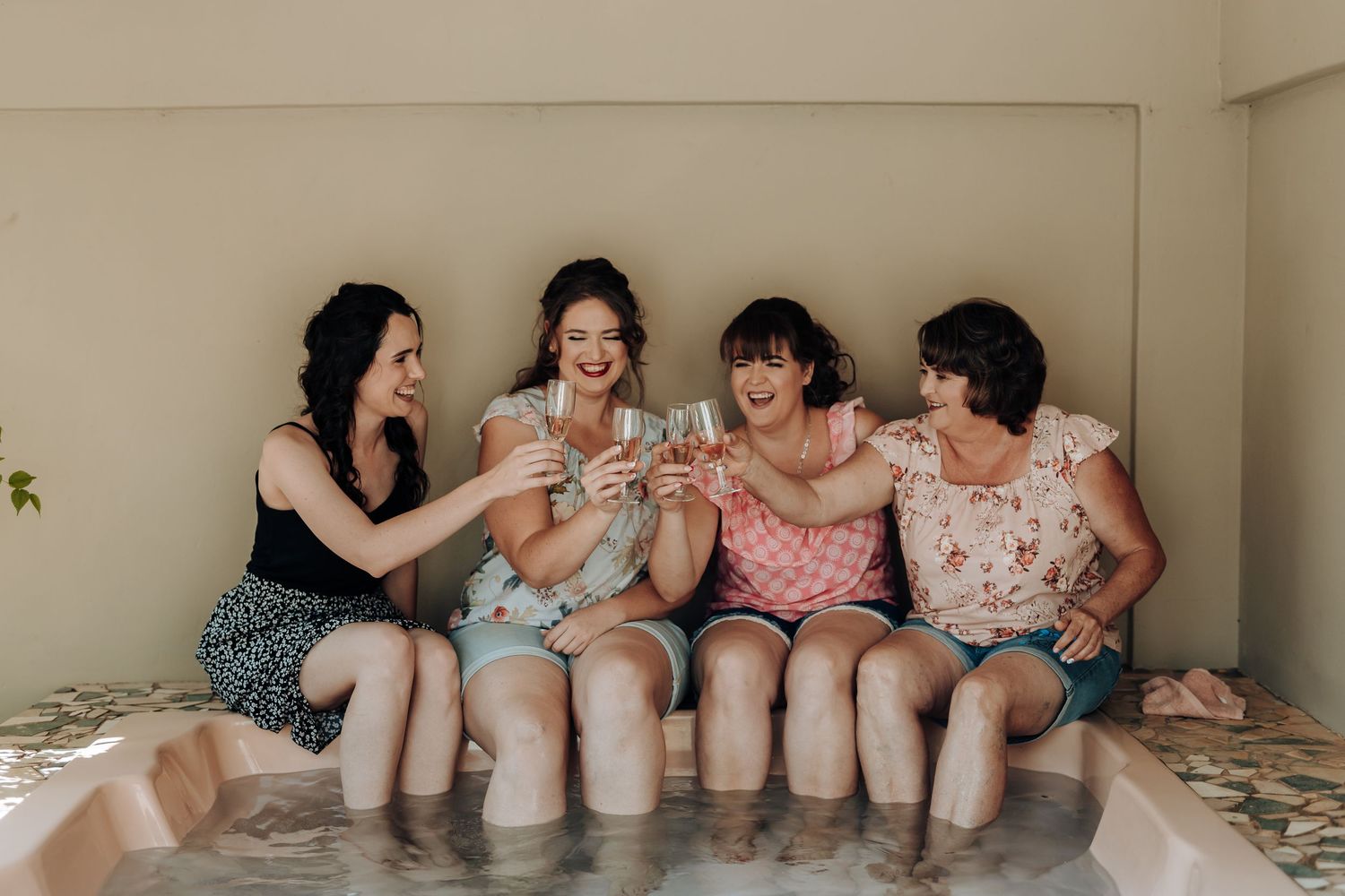 Friends relaxing and laughing together while sitting in a hot tub.