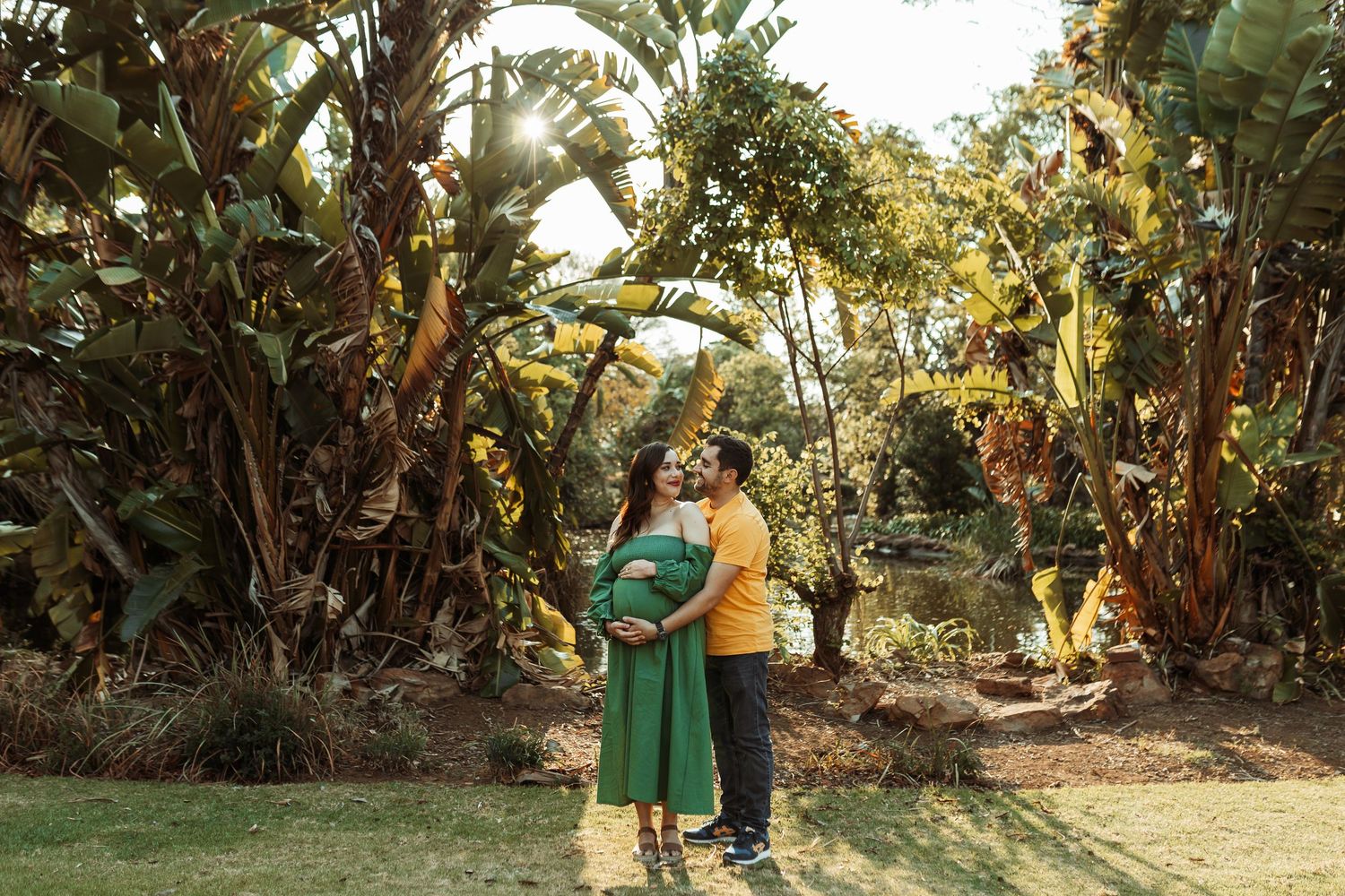 Young couple in traditional dress dances a passionate Argentine tango together among tropical greenery.