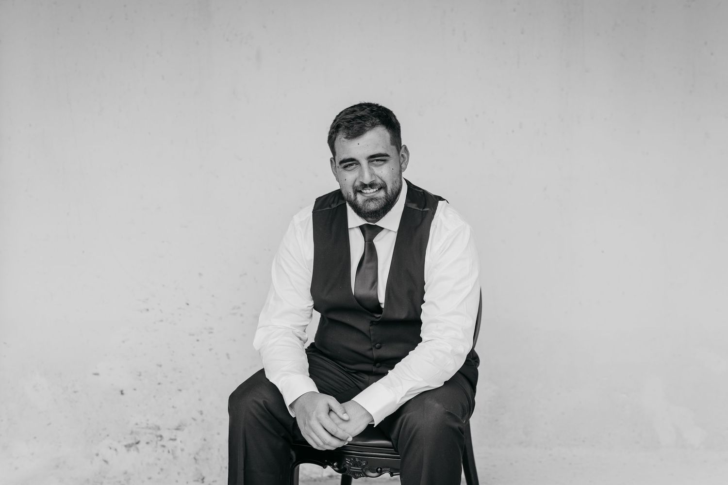 A series of vintage black and white photographs showing a person in a vest posing in different seated positions.