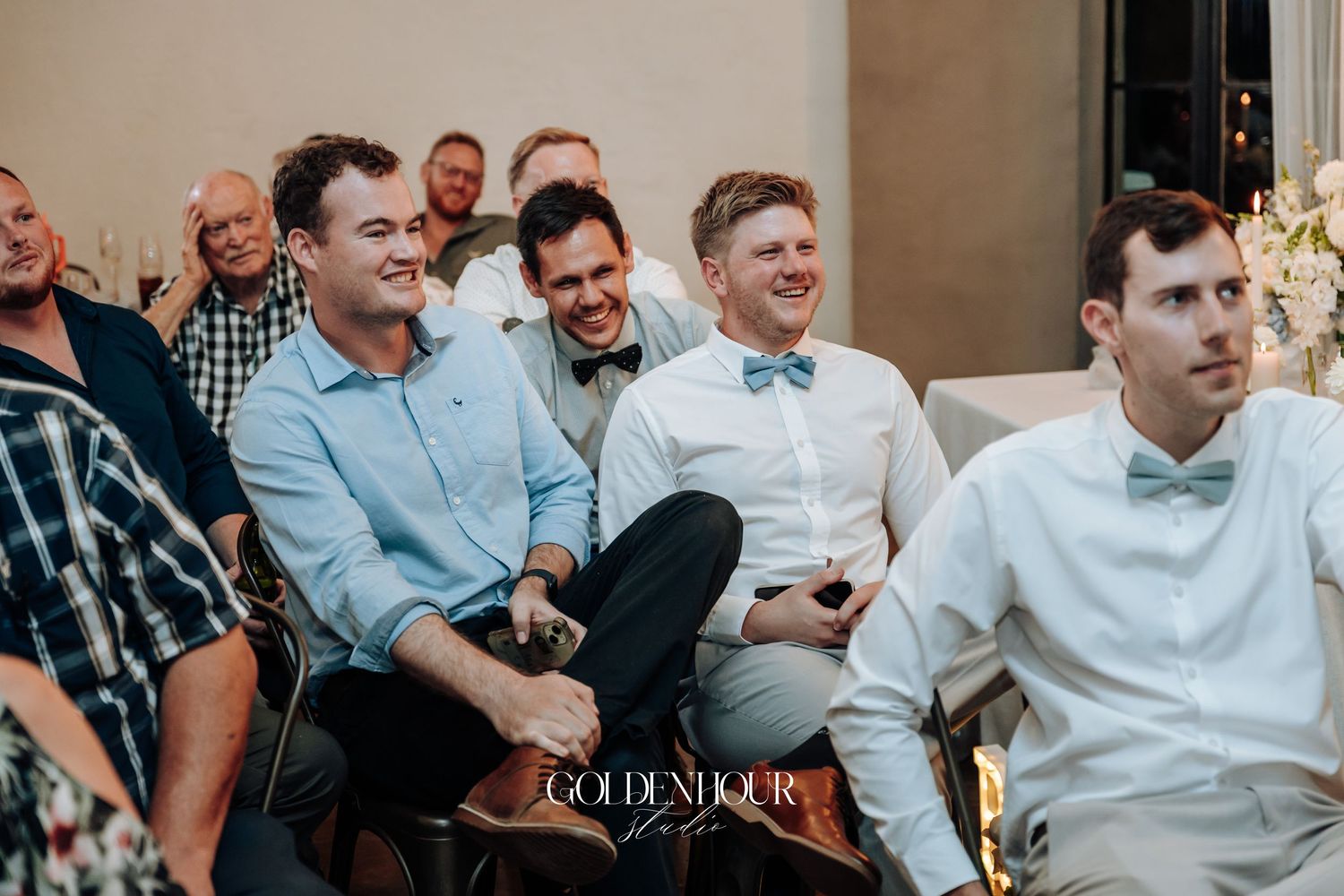 Wedding guests enjoying candid moments during reception celebration.