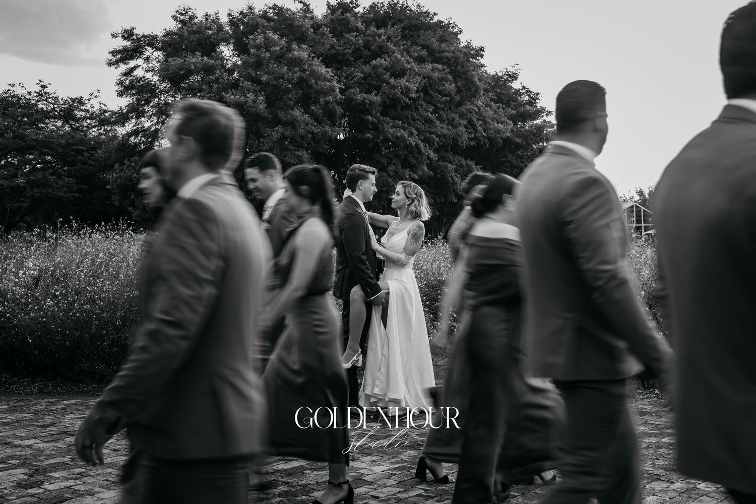 Wedding party walks together in stylish motion blur effect.