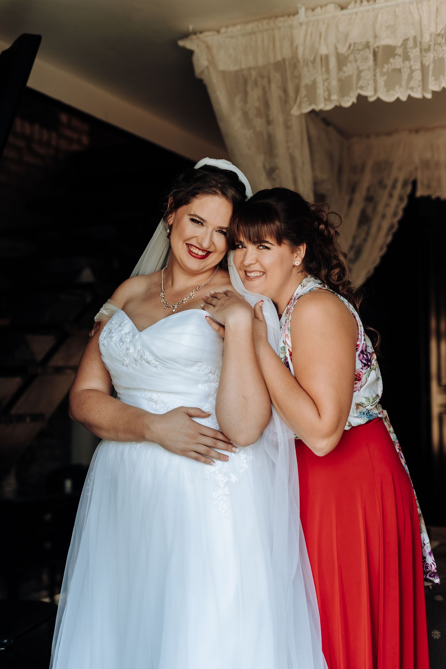 Candid wedding photo showing two people sharing a happy moment together.