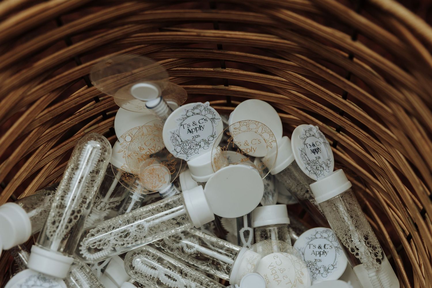 Close-up view of white medicine capsules and pills scattered in a woven wicker basket.