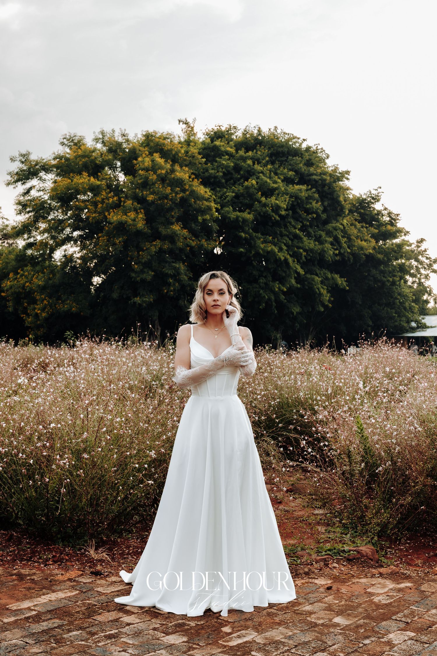 White wedding dress photographed in a field of wildflowers.