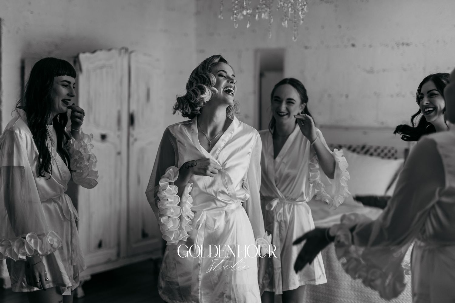 Wedding party getting ready in black and white photography with natural window light.