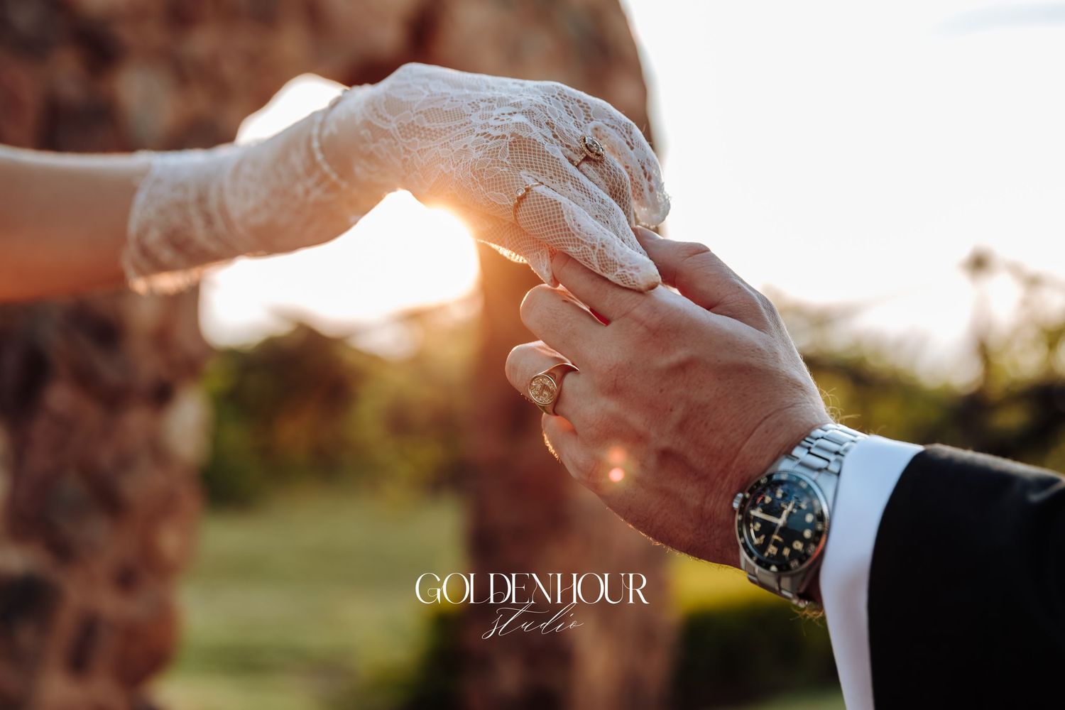 Close-up details of hands and rings during intimate wedding moment.