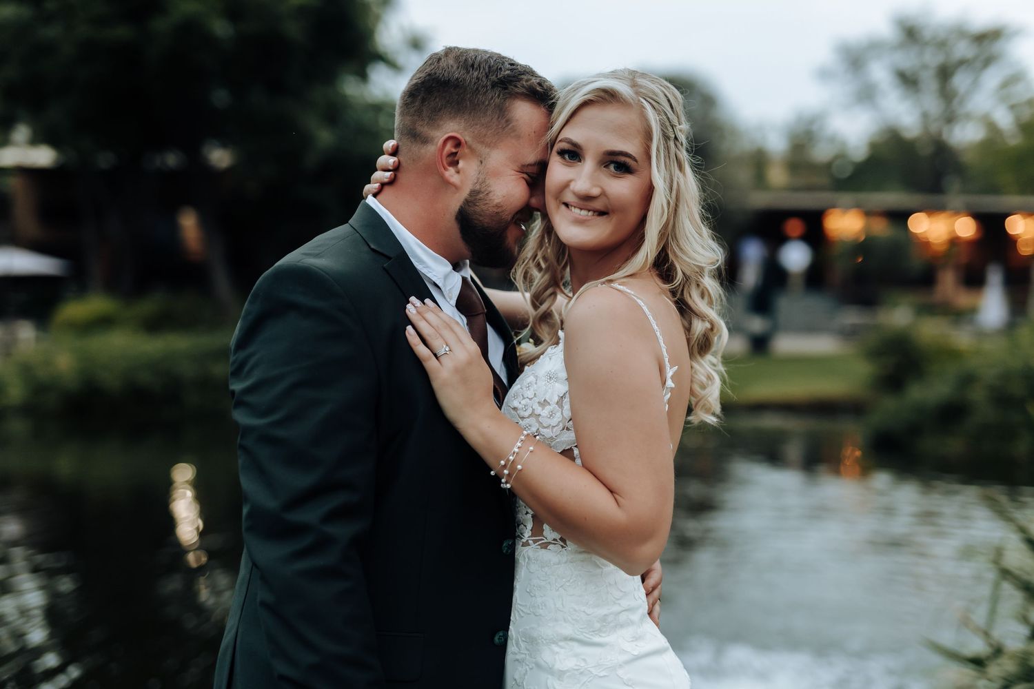 A romantic couple shares tender moments in a garden setting during their wedding photo session.