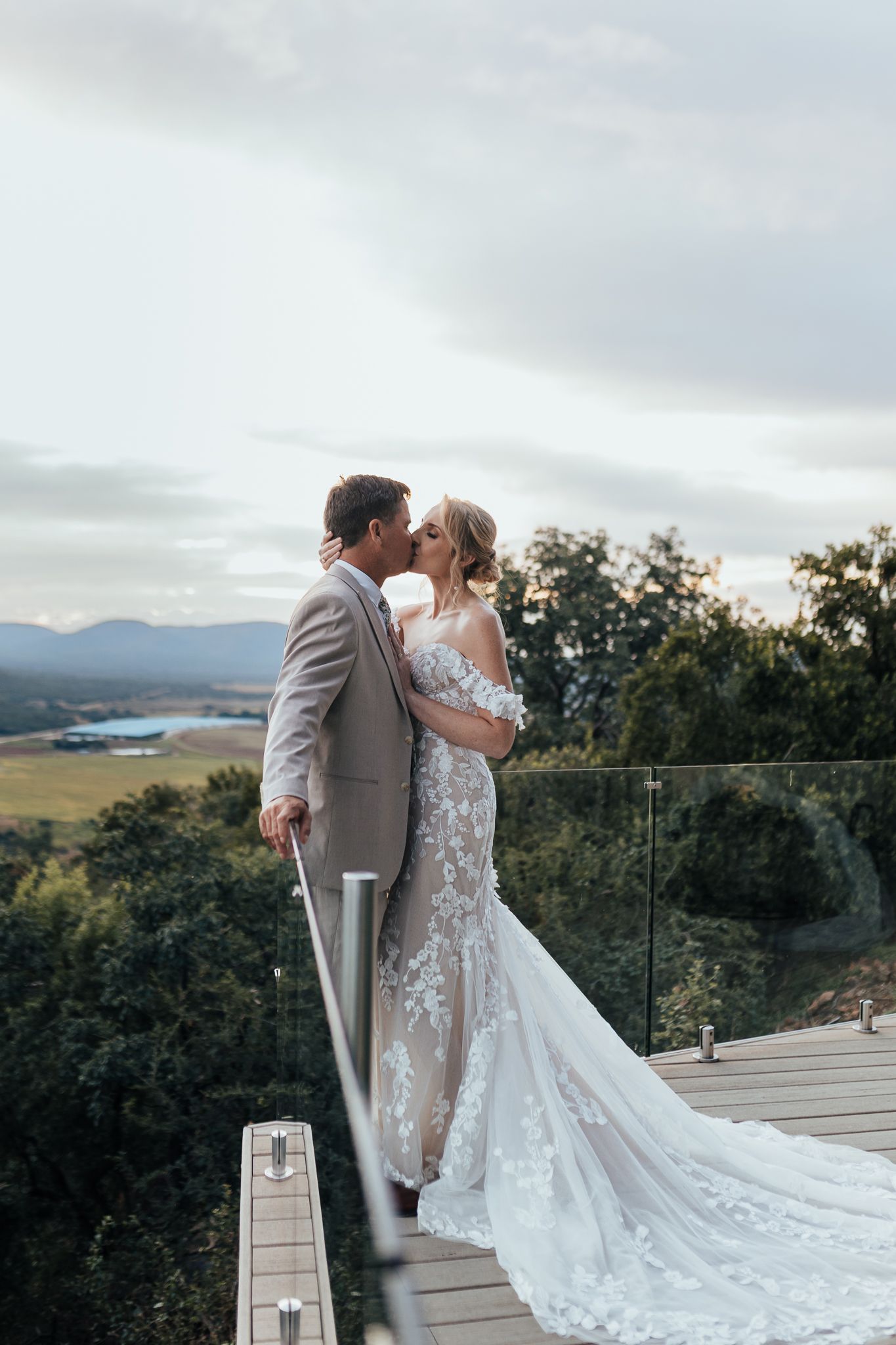Intimate wedding moment captured on a mountain deck with panoramic valley views.