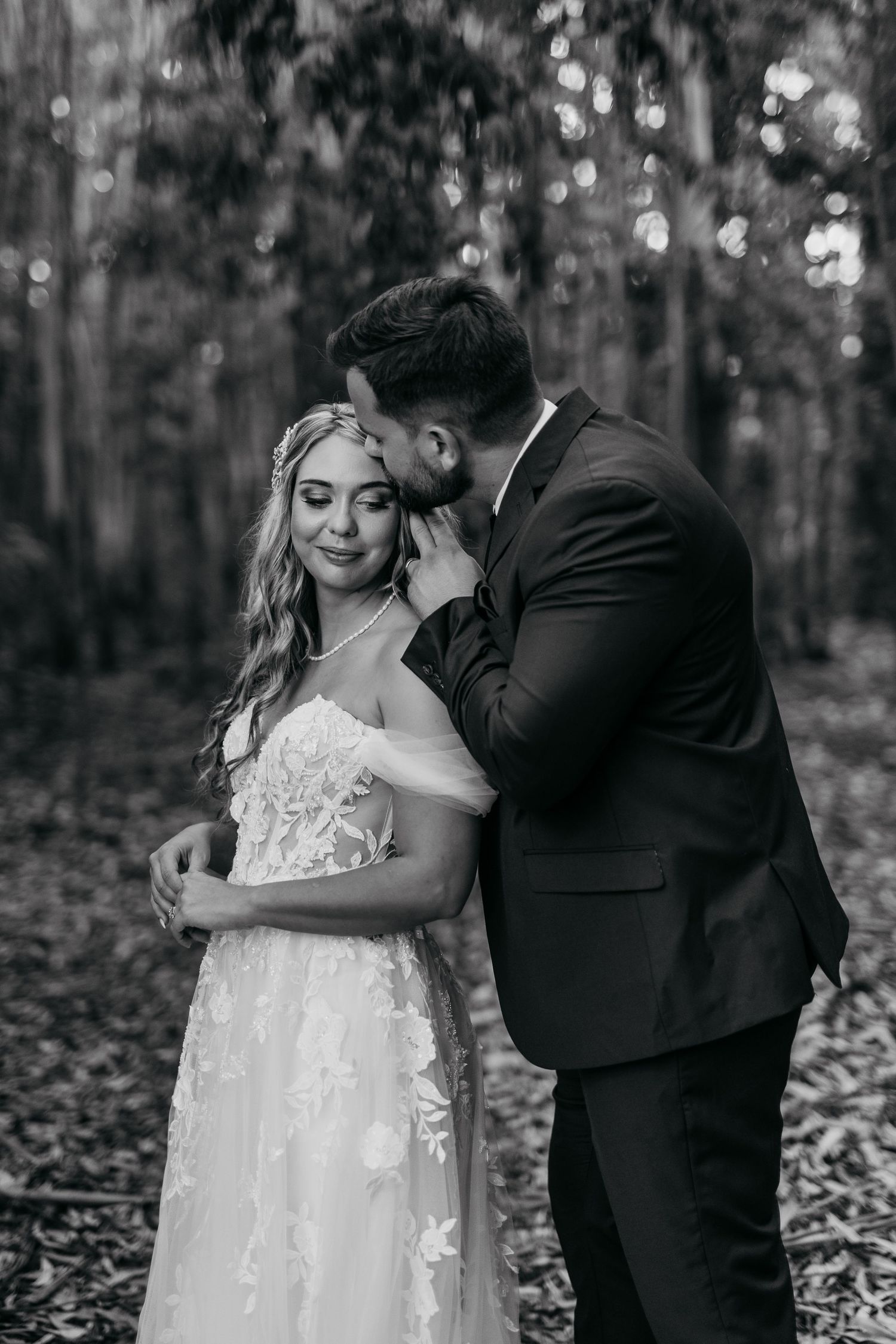 A romantic black and white wedding photo sequence showing a couple embracing in a forest setting.