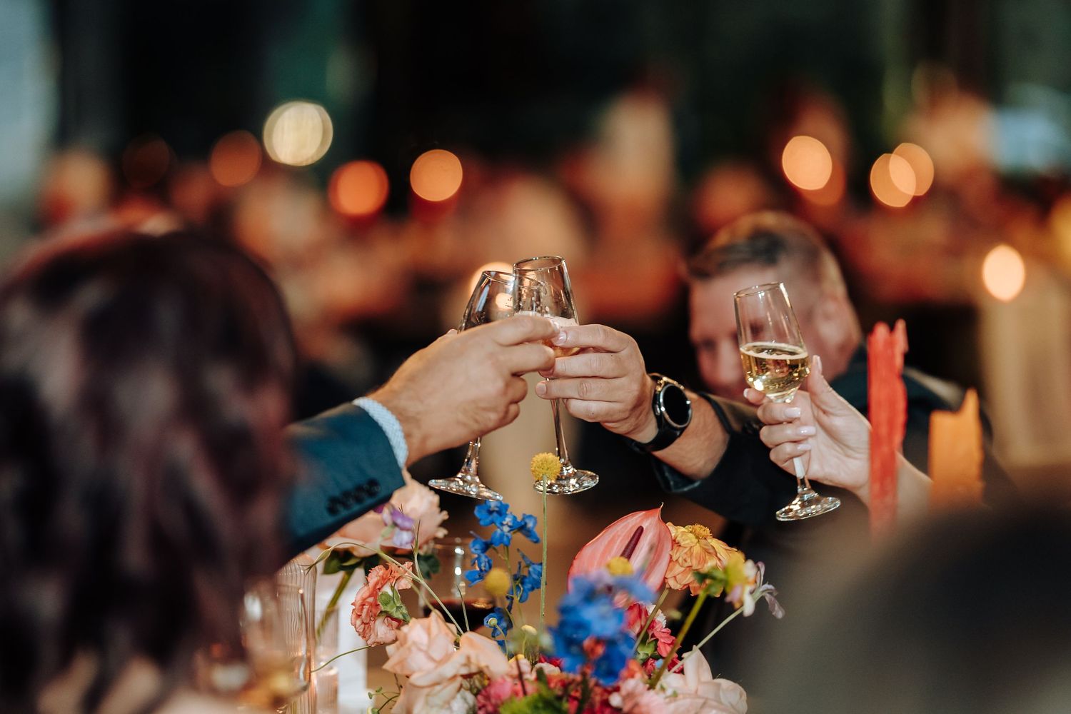 Close-up of colorful reception decor with bokeh lights in the background.