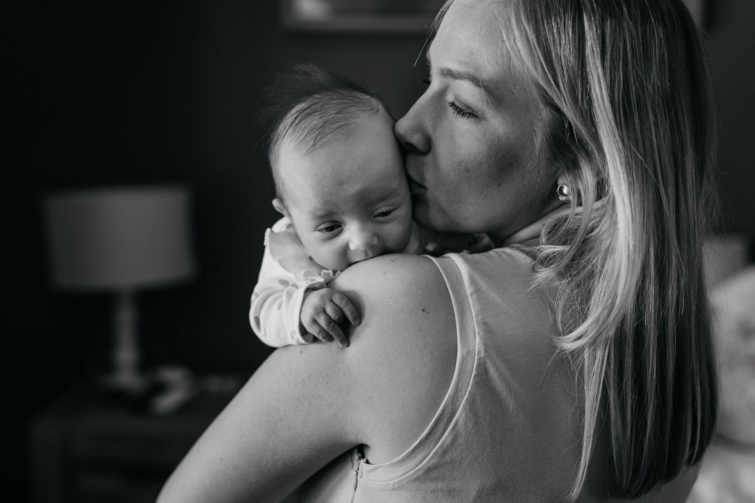 Intimate black and white portraits capturing gentle moments between parent and child.